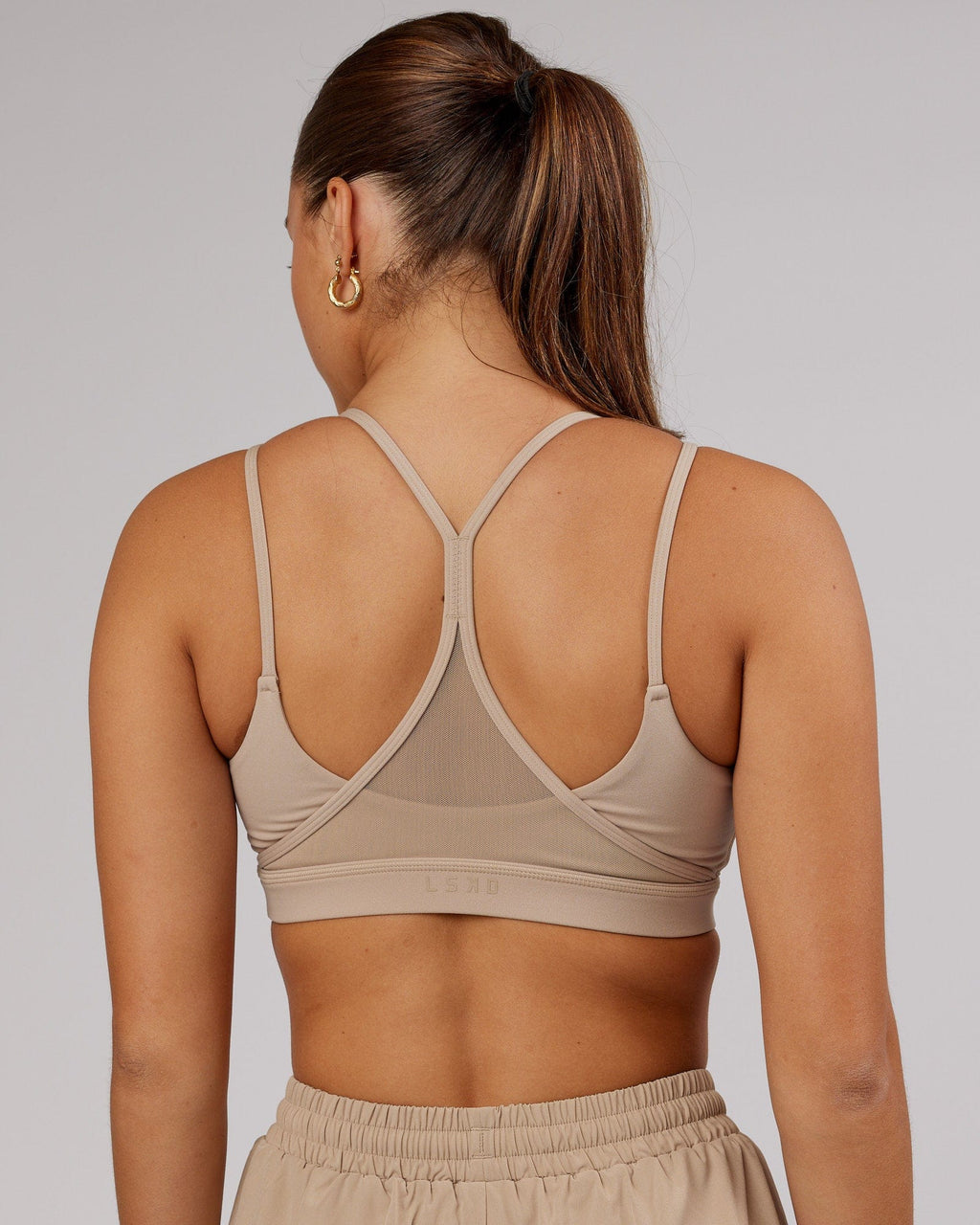 Model wearing Movement Sports Bra - Taupe