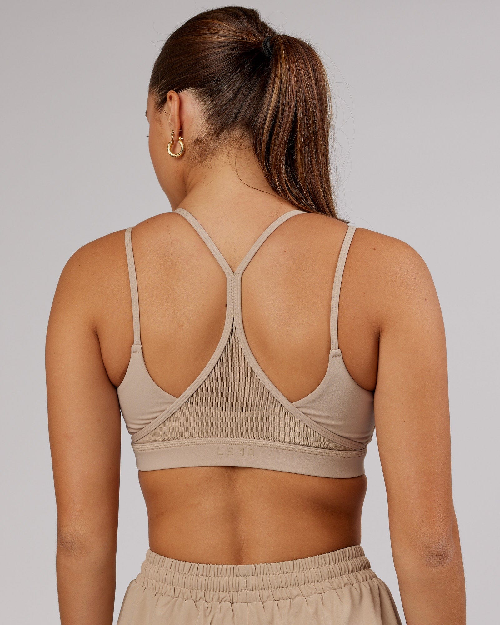 Model wearing Movement Sports Bra - Taupe