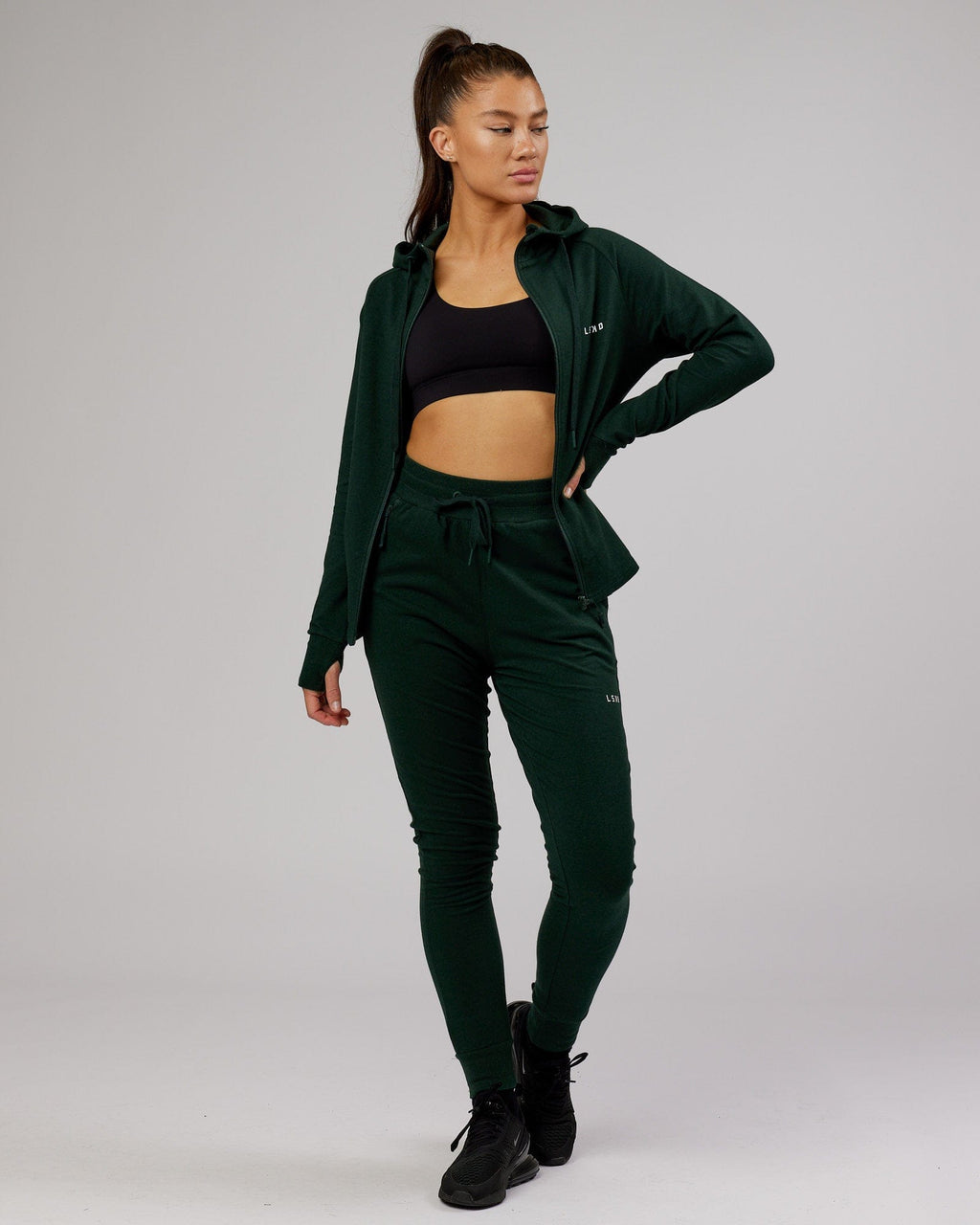 Model wearing PB Zip Through Hoodie - Forest-Tonal