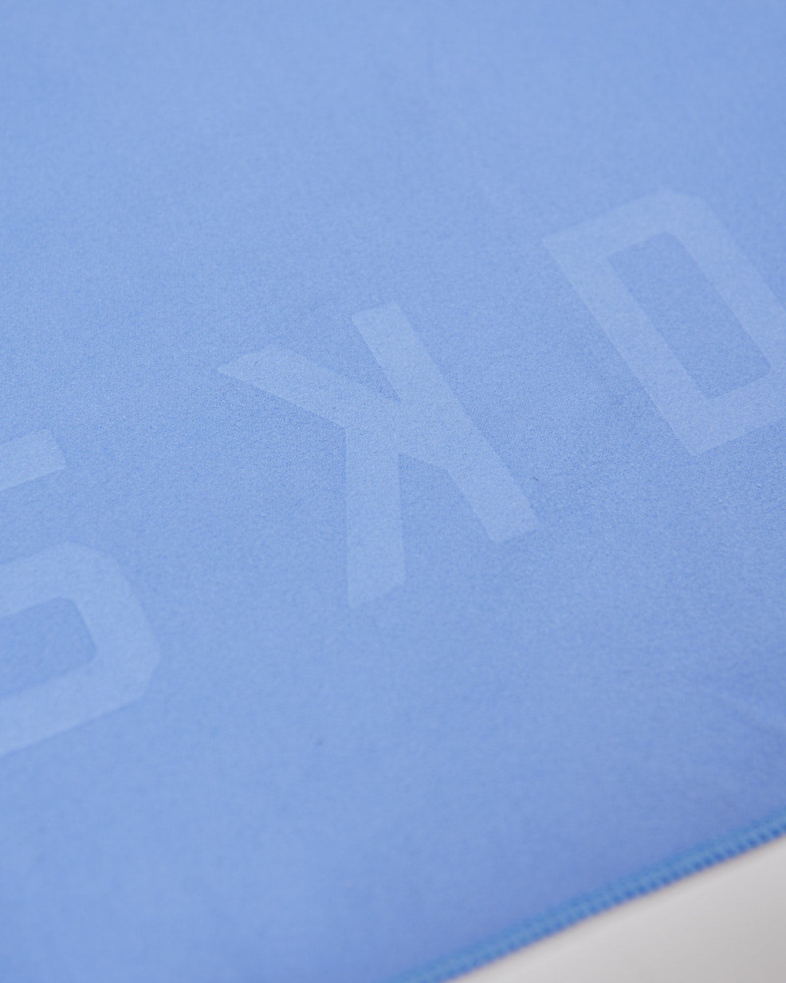 Model wearing Perform Lightweight Microfibre Towel - Cornflower Blue