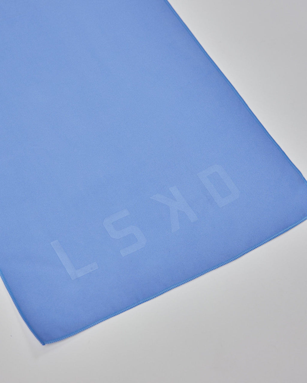 Model wearing Perform Lightweight Microfibre Towel - Cornflower Blue