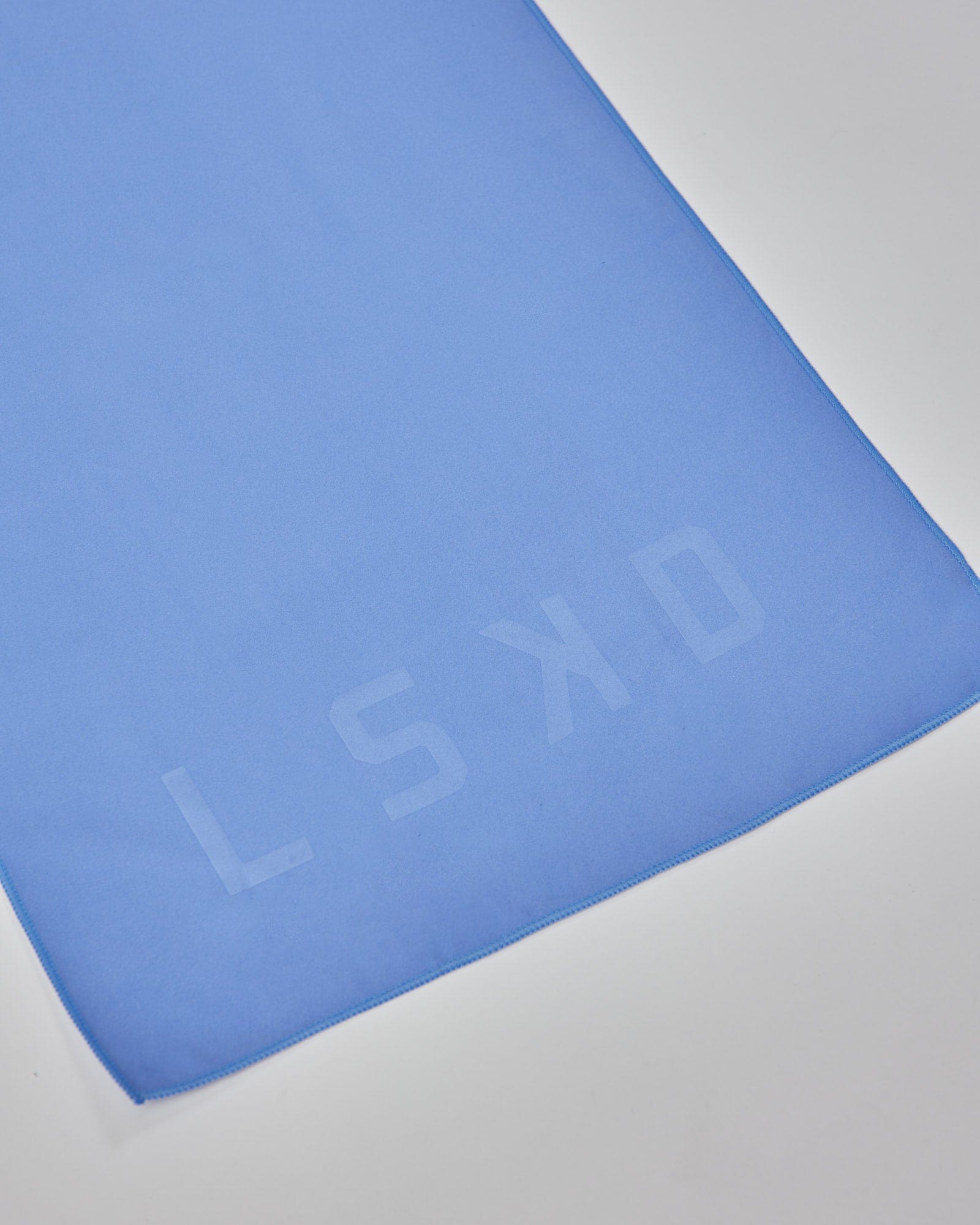Model wearing Perform Lightweight Microfibre Towel - Cornflower Blue