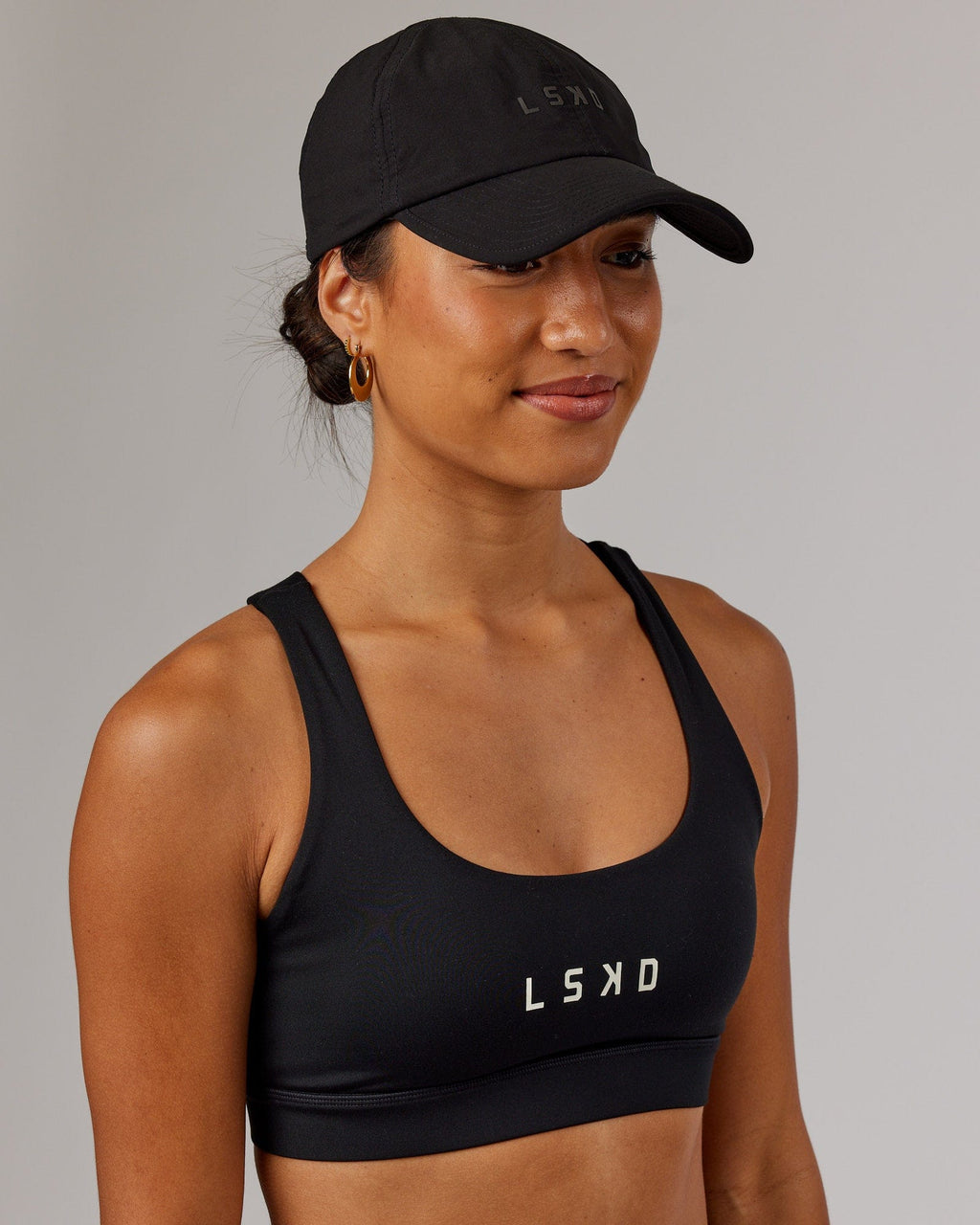 Model wearing Performance Tech Cap - Black