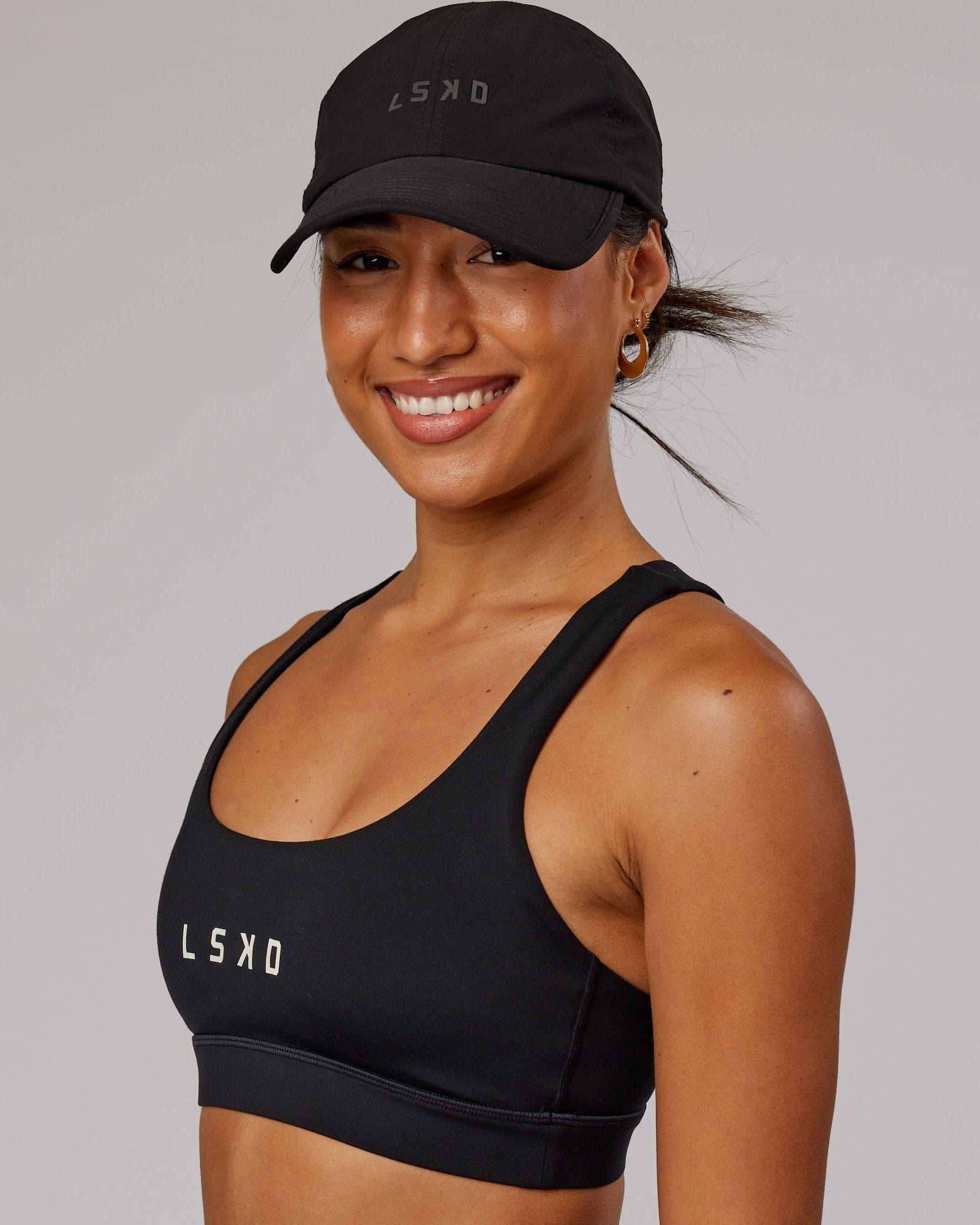 Model wearing Performance Tech Cap - Black