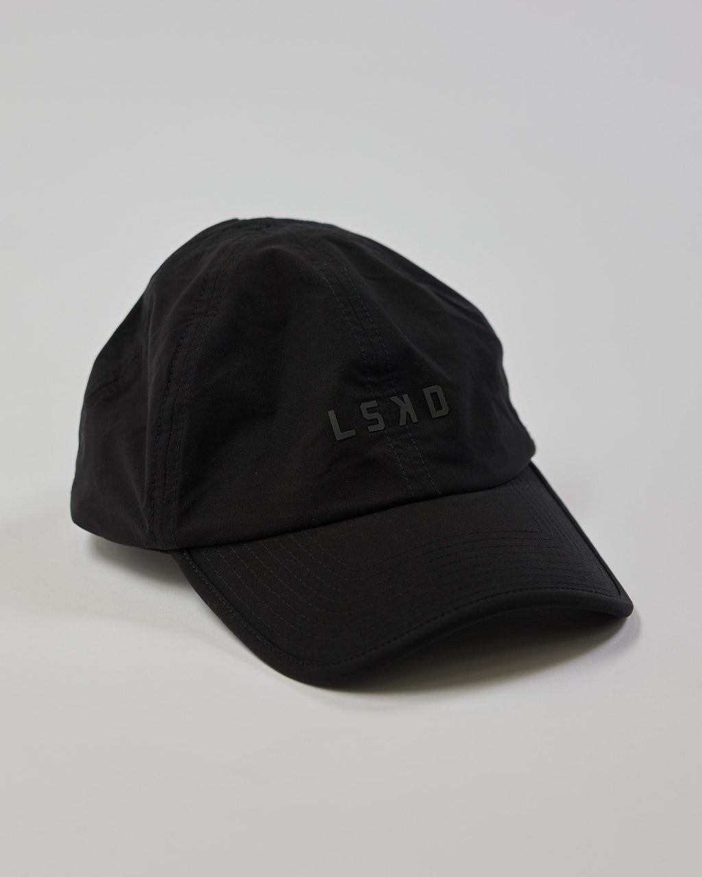 Model wearing Performance Tech Cap - Black