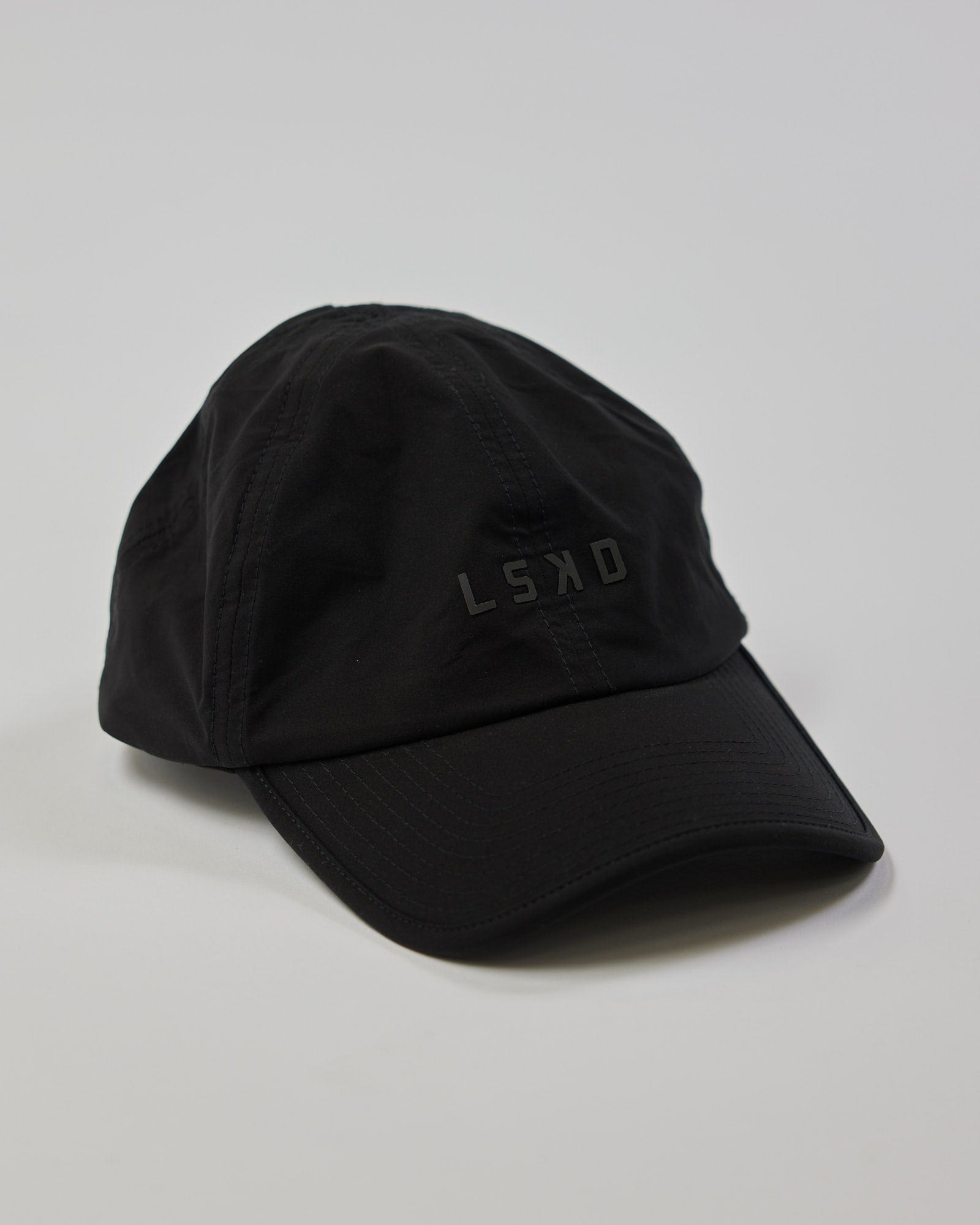 Model wearing Performance Tech Cap - Black