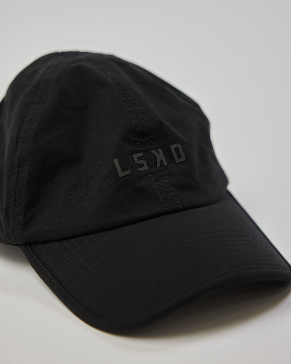 Model wearing Performance Tech Cap - Black