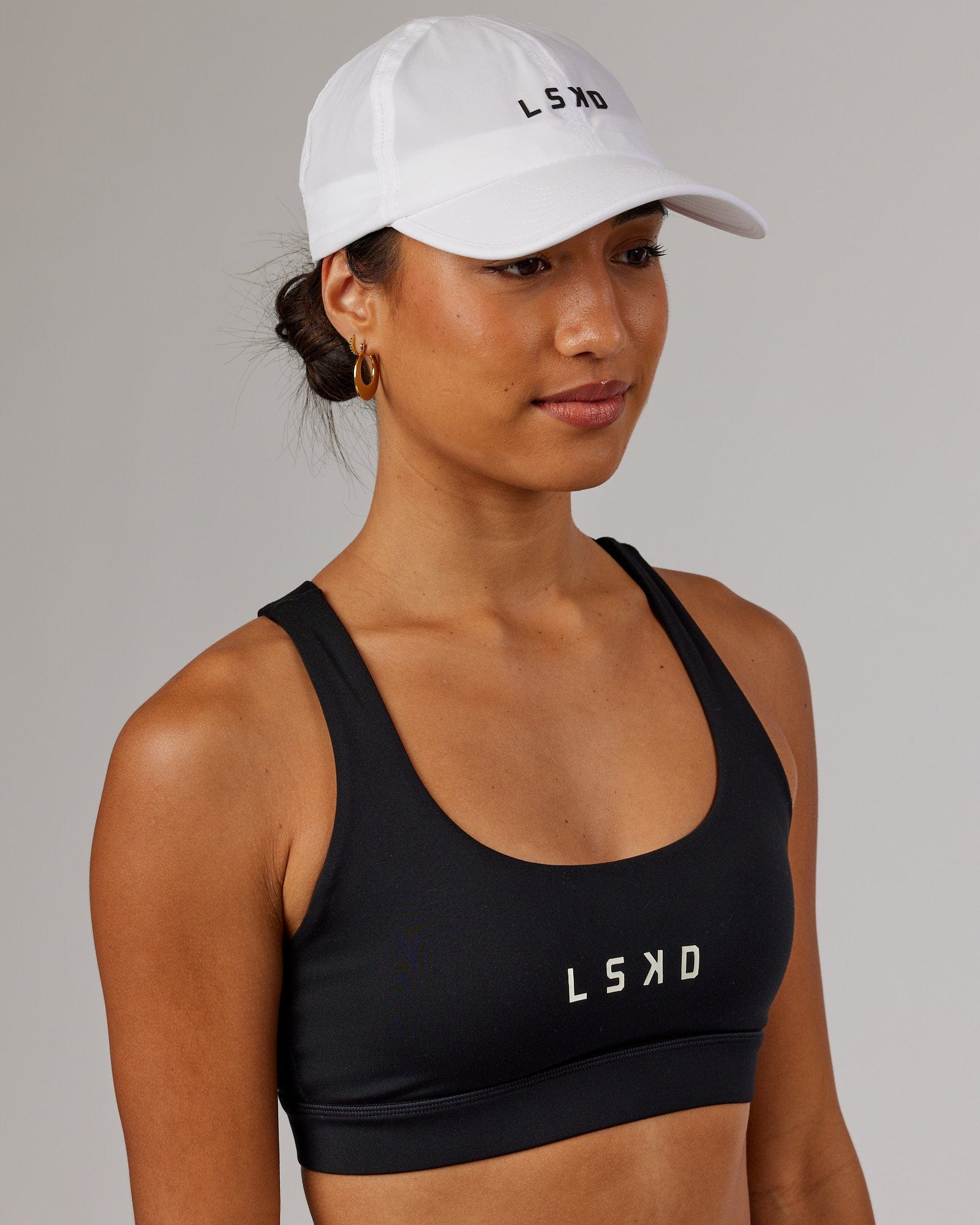 Model wearing Performance Tech Cap - White