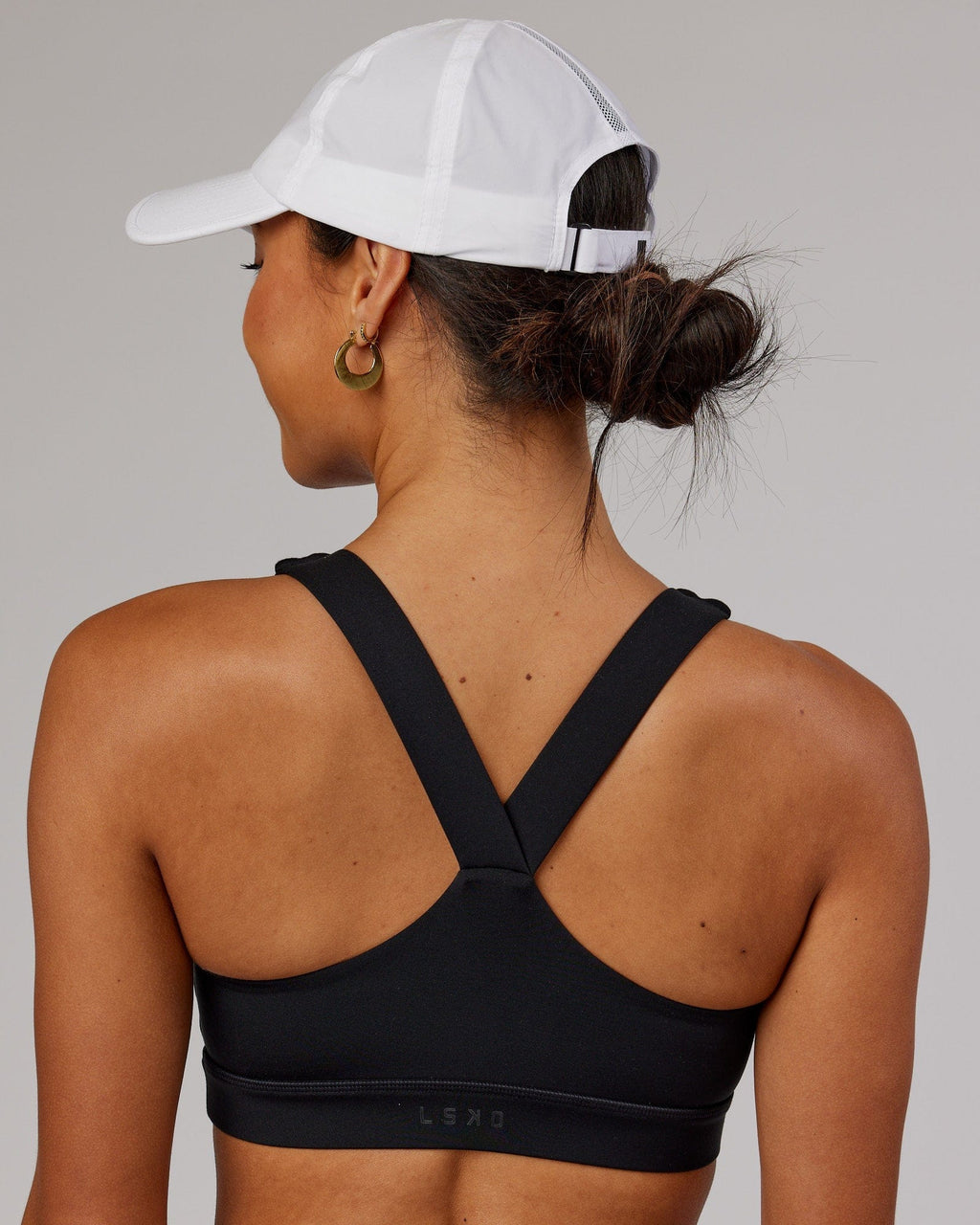Model wearing Performance Tech Cap - White