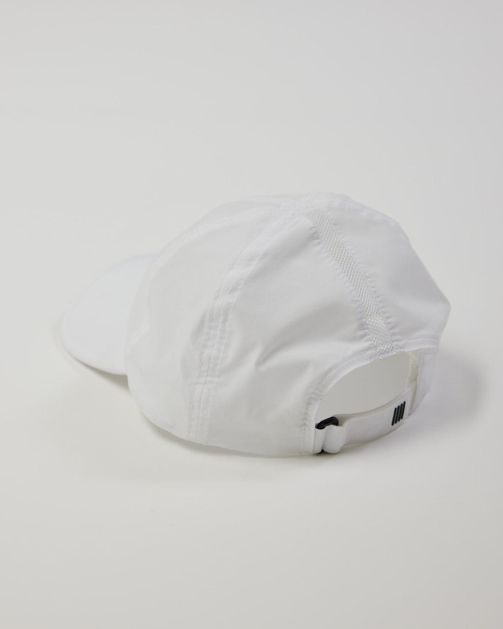 Model wearing Performance Tech Cap - White