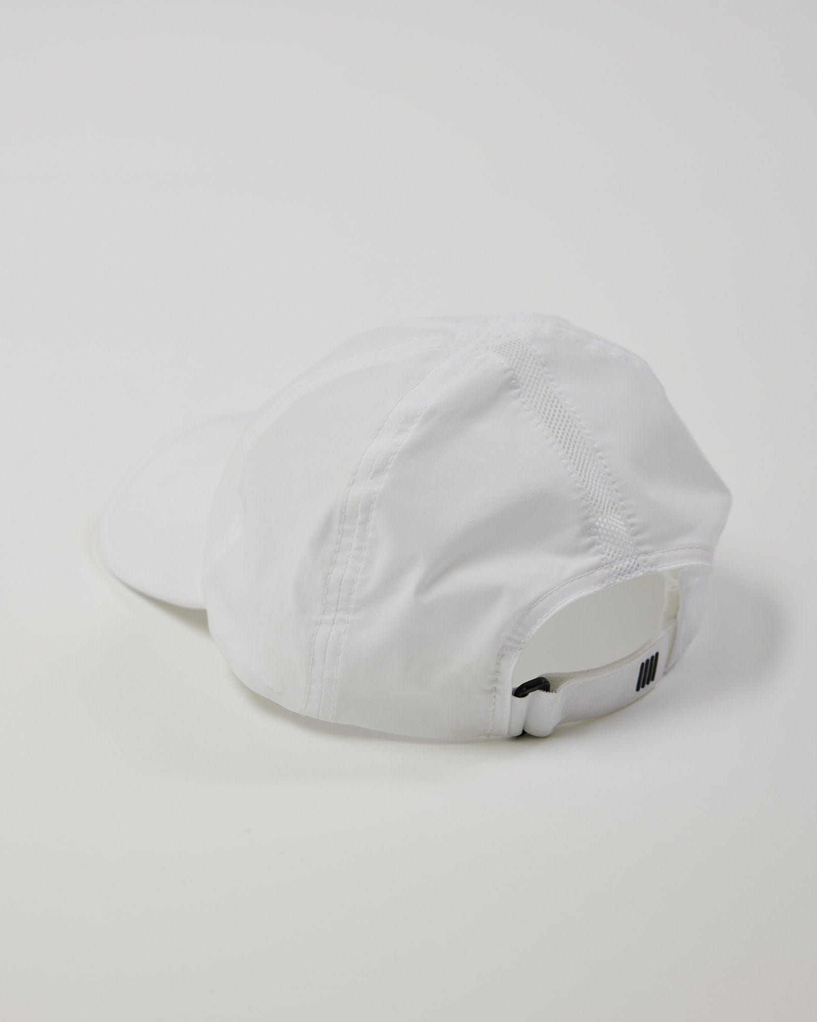 Model wearing Performance Tech Cap - White