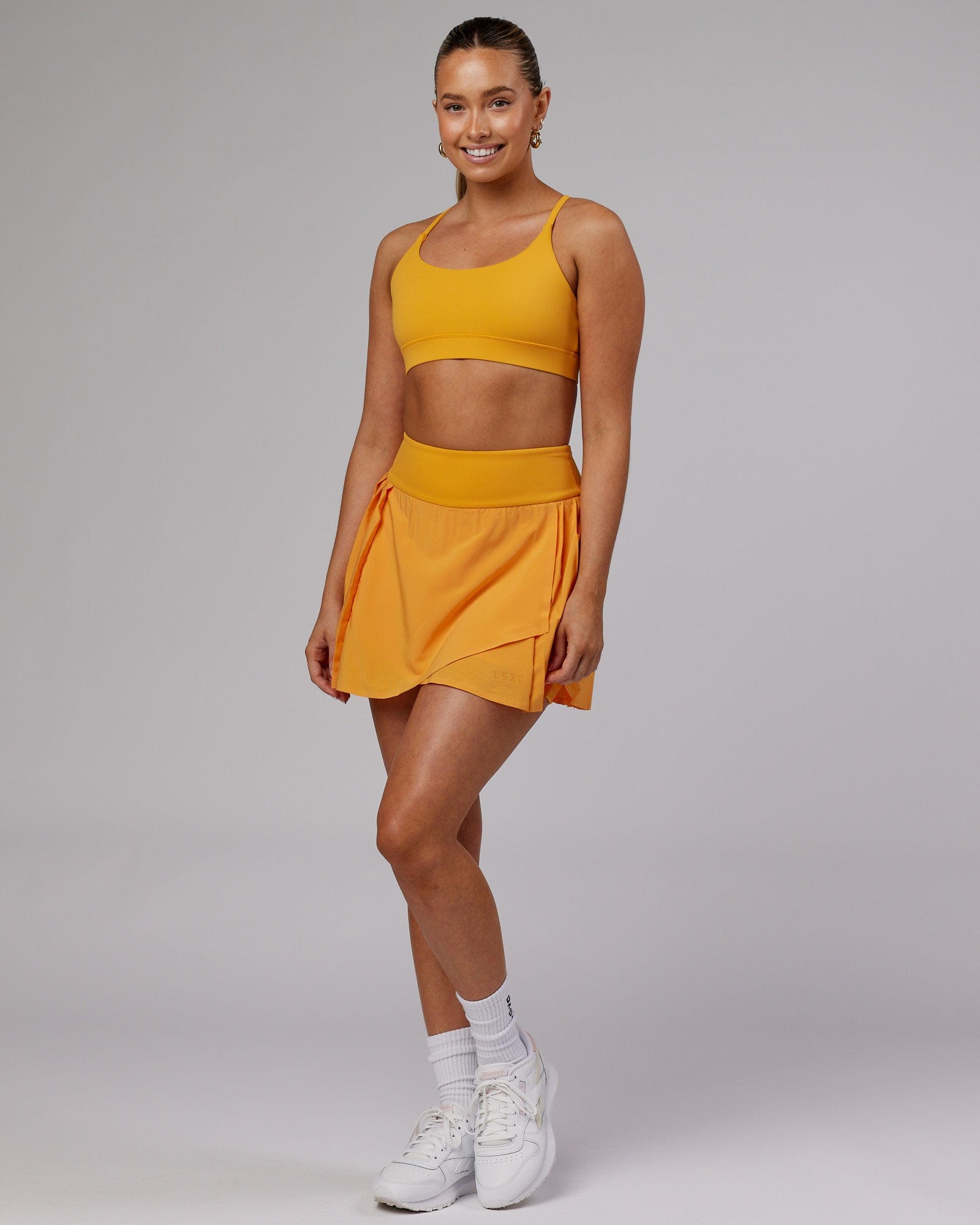 Model wearing Rally Tennis Skirt - Butterscotch