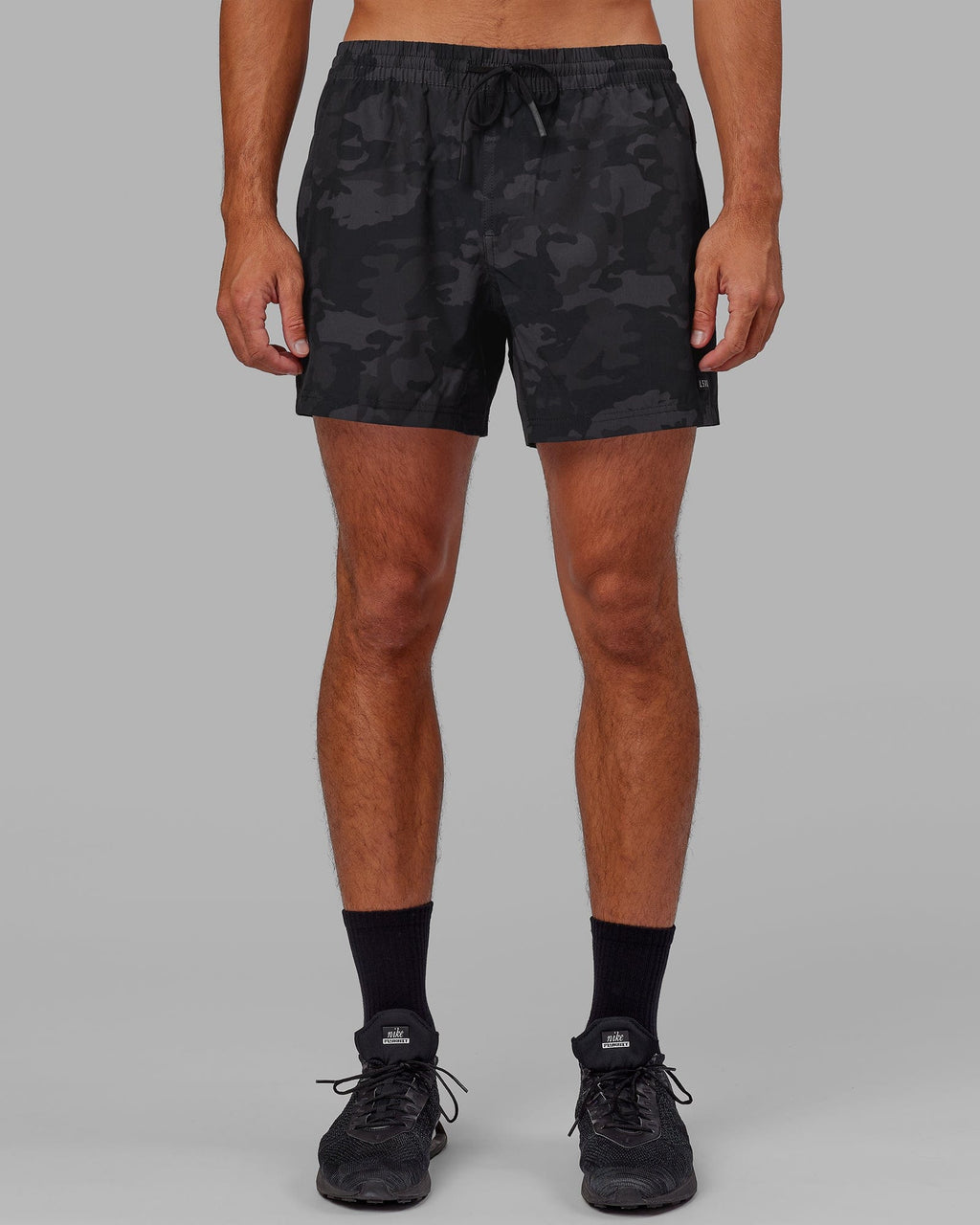 Model wearing Rep 5" Performance Short - Black Camo