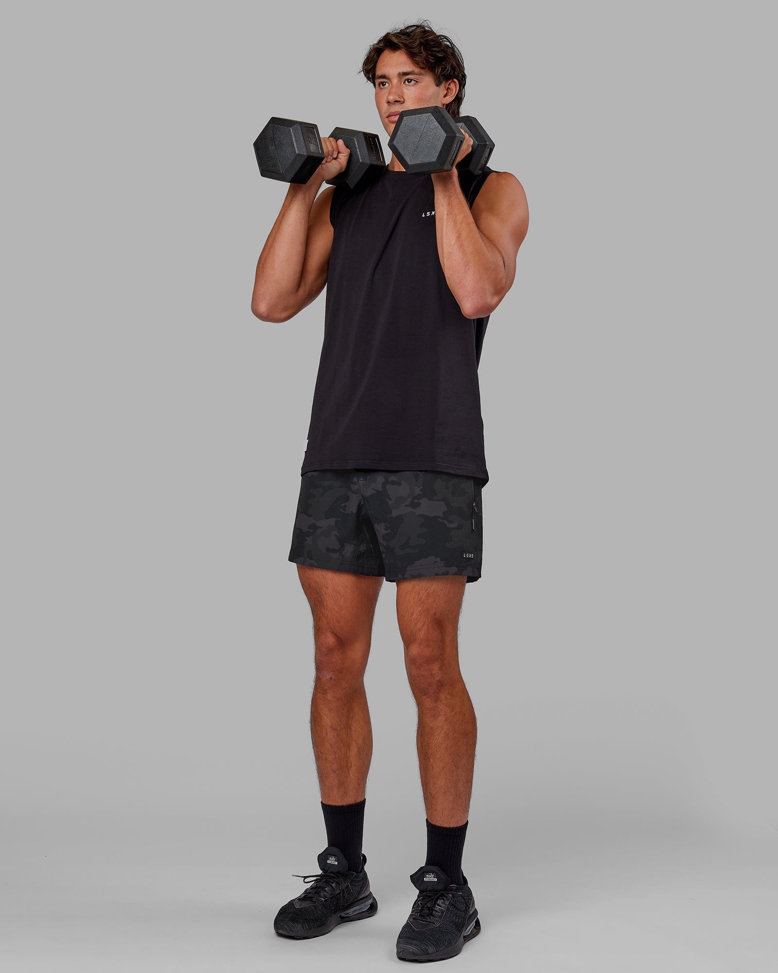 Model wearing Rep 5" Performance Short - Black Camo