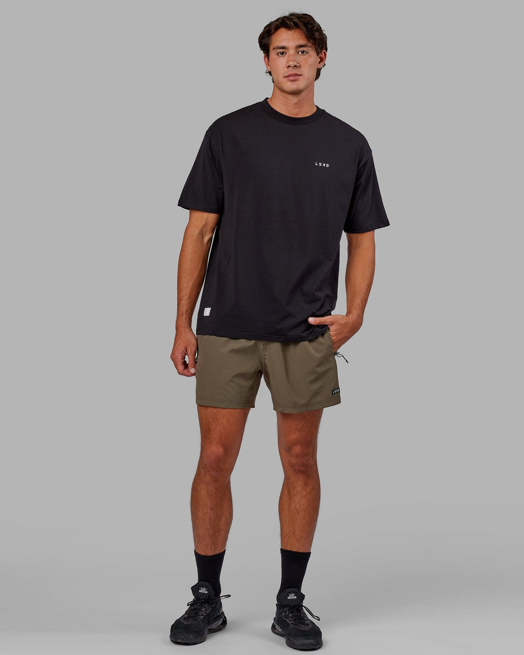 Model wearing Rep 5" Performance Short - Olive Leaf