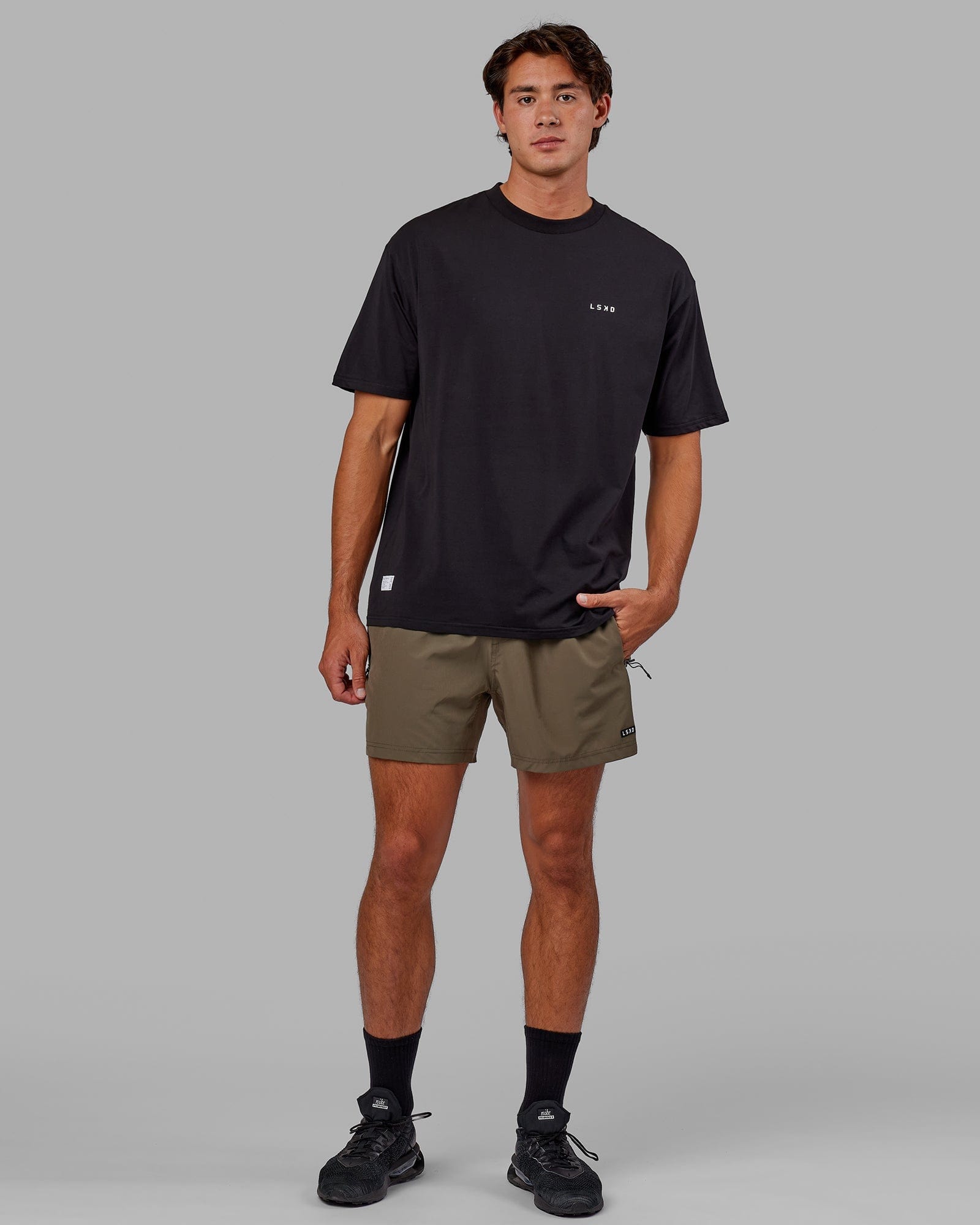 Model wearing Rep 5" Performance Short - Olive Leaf