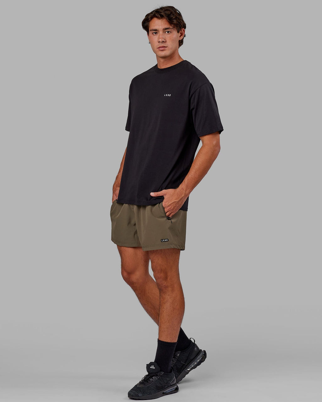 Model wearing Rep 5" Performance Short - Olive Leaf