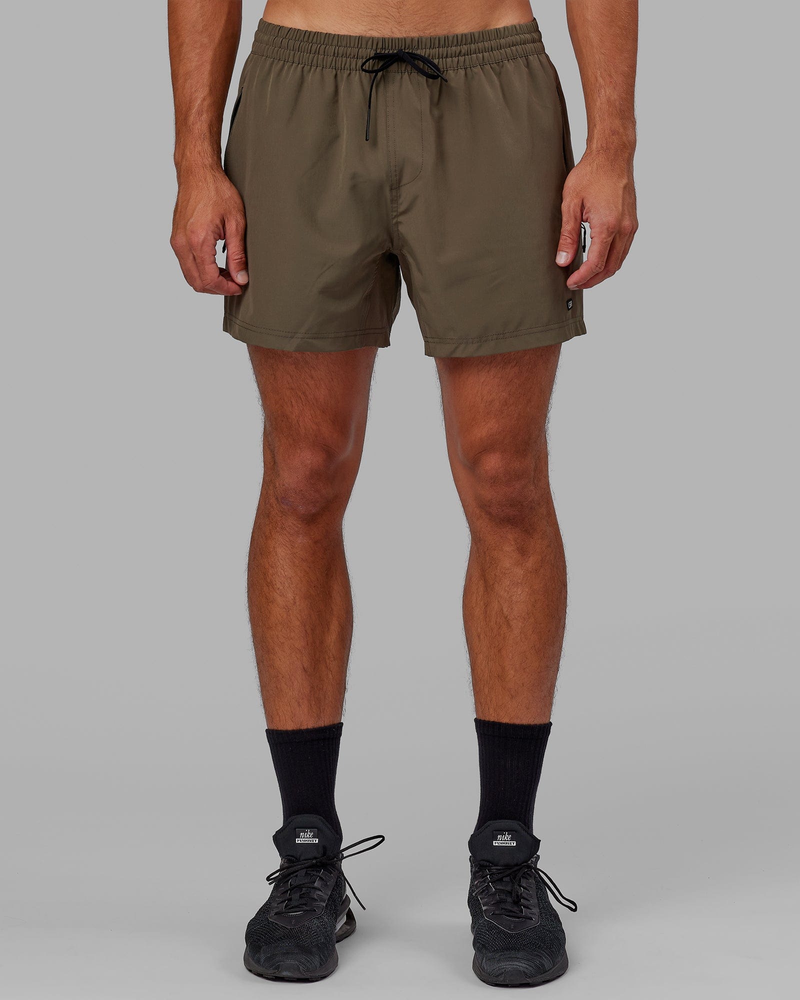 Model wearing Rep 5" Performance Short - Olive Leaf