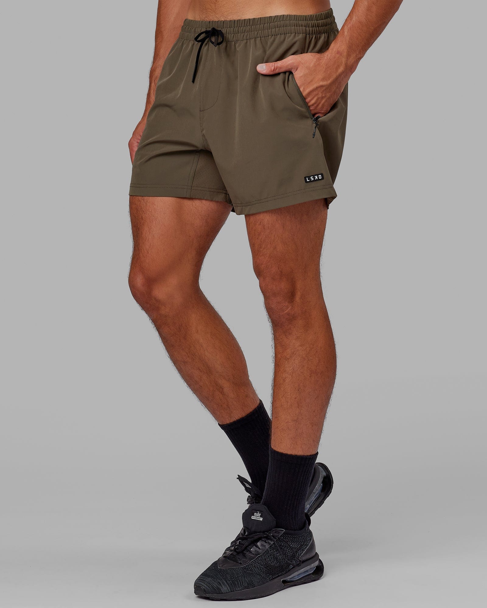 Model wearing Rep 5" Performance Short - Olive Leaf