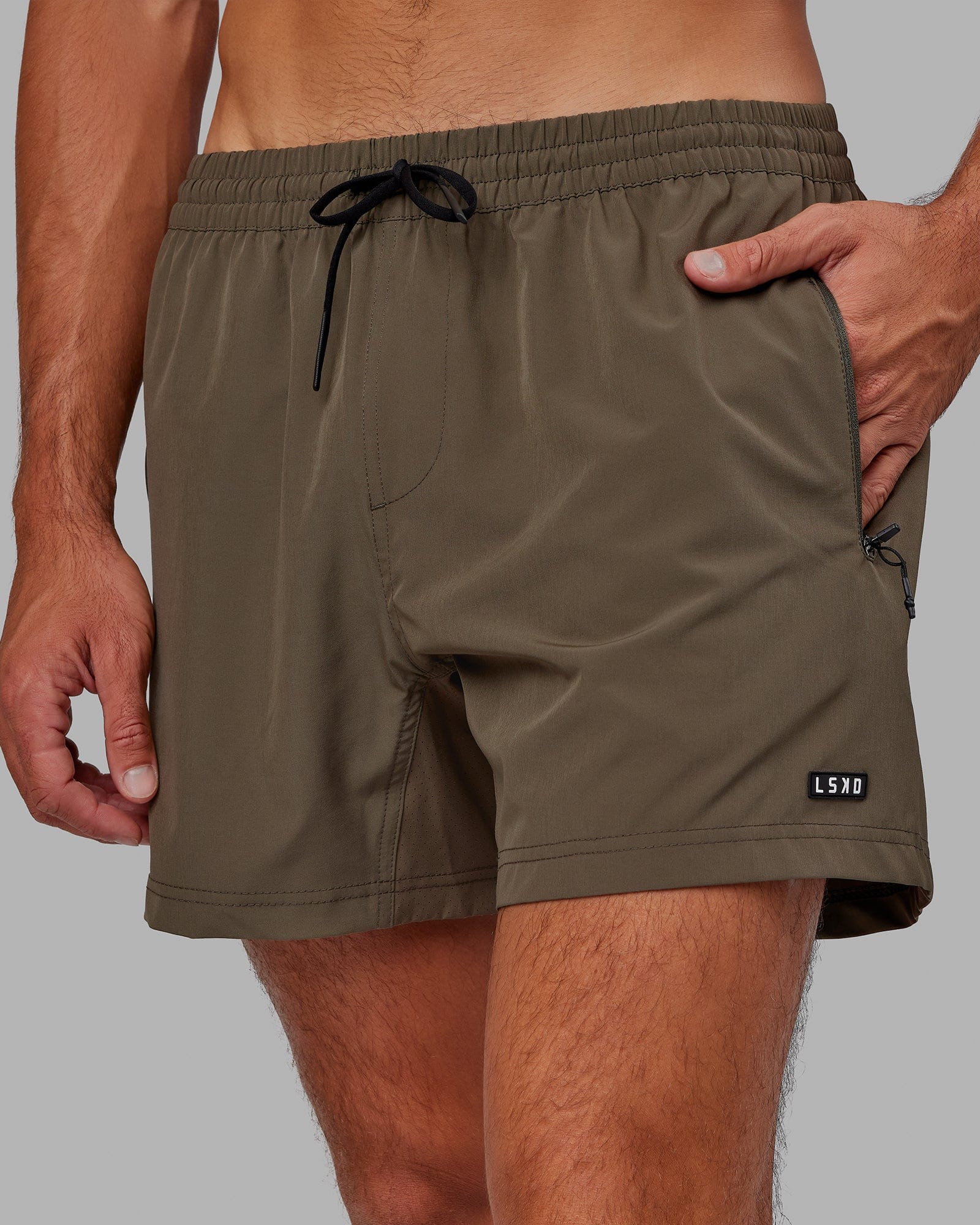 Model wearing Rep 5" Performance Short - Olive Leaf
