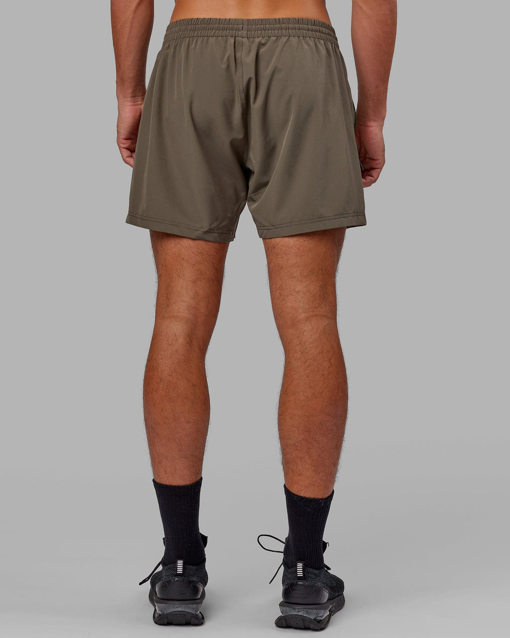 Model wearing Rep 5" Performance Short - Olive Leaf
