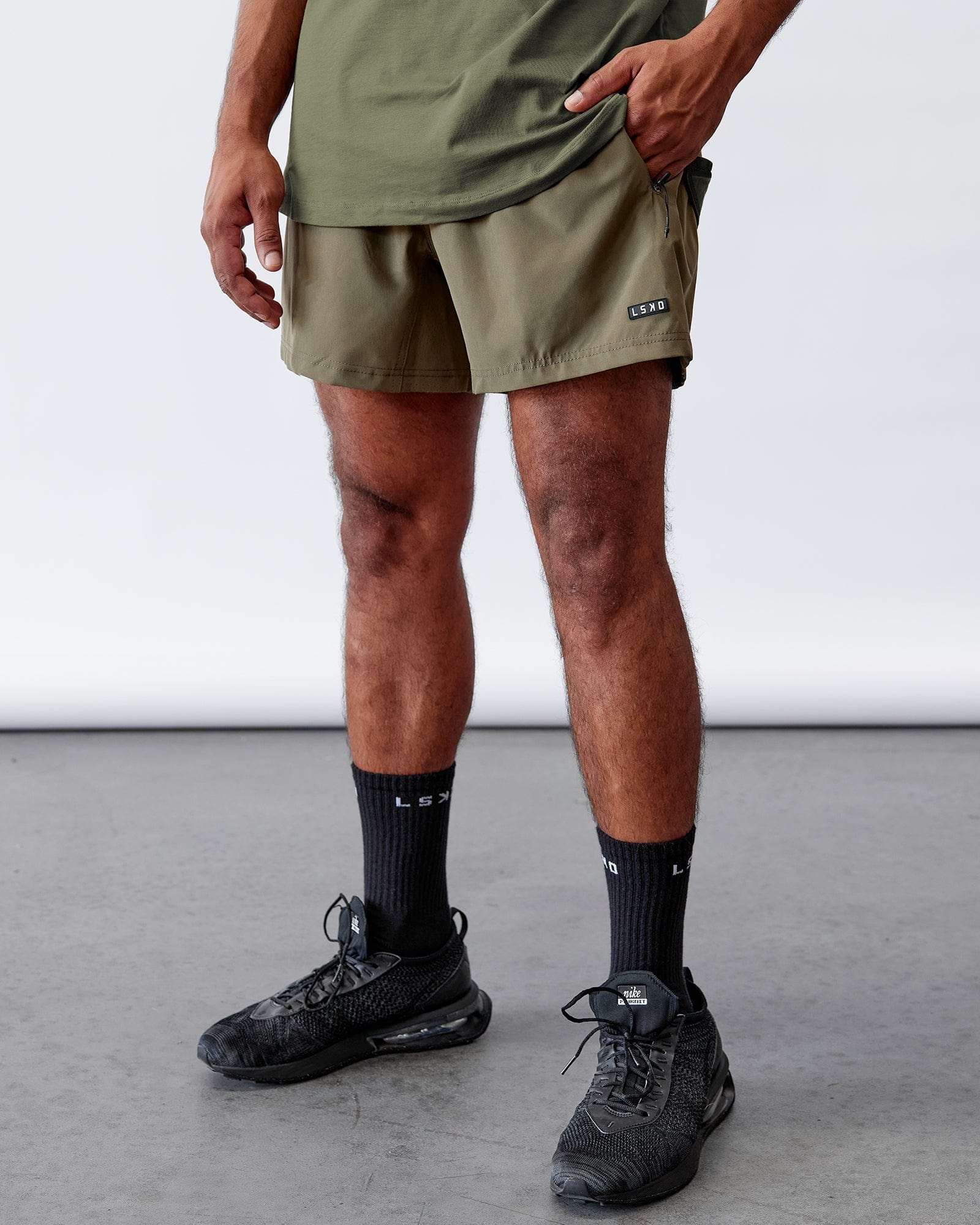 Model wearing Rep 5" Performance Short - Olive Leaf