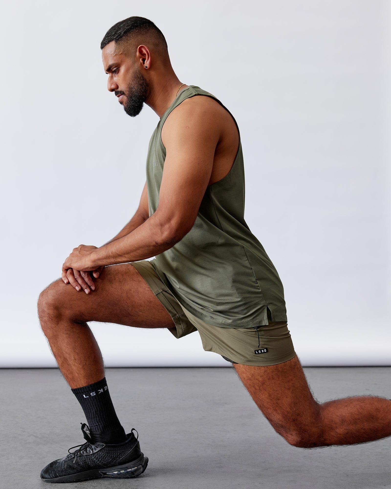 Model wearing Rep 5" Performance Short - Olive Leaf