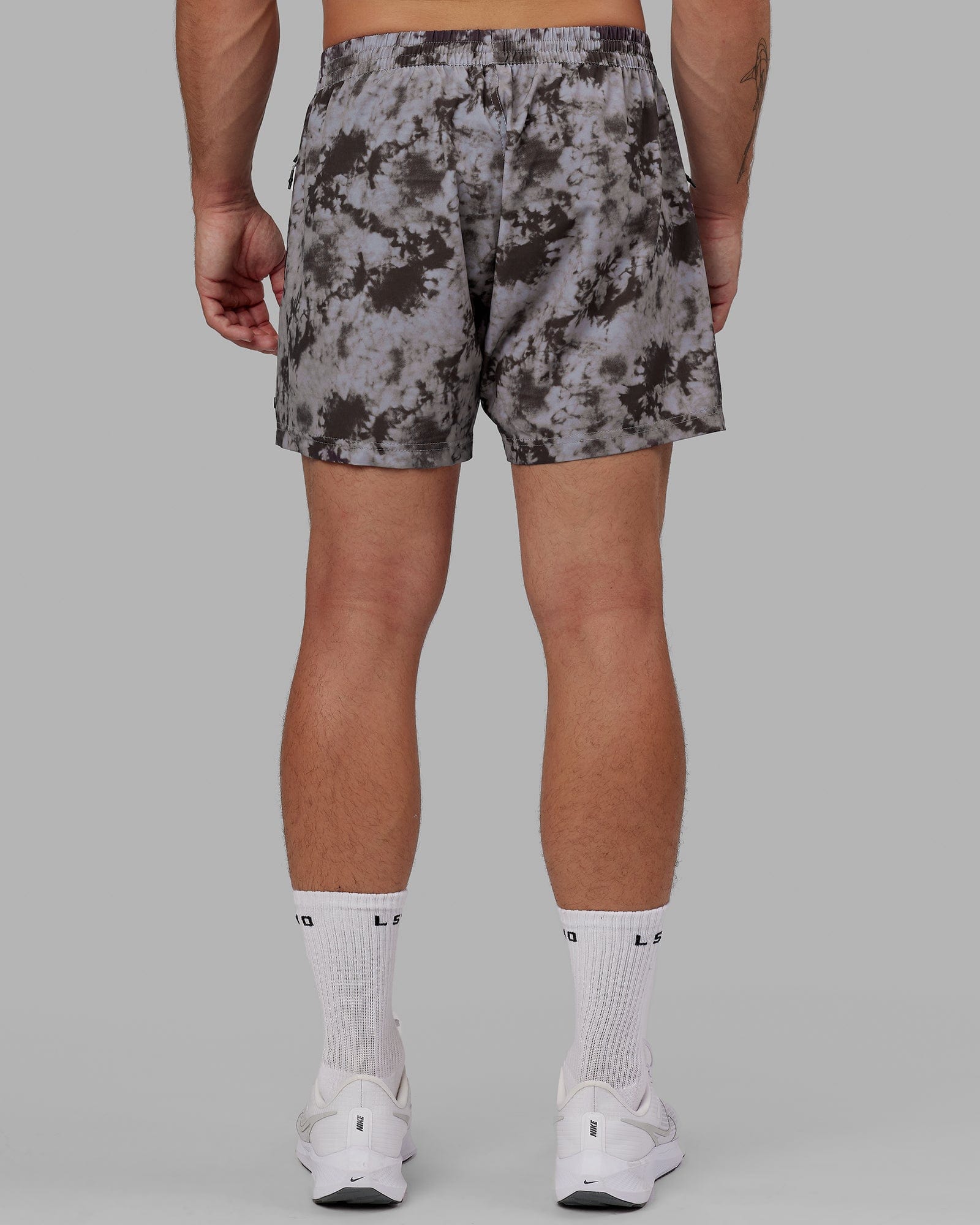 Model wearing Rep 5" Performance Short - Asphalt Tie Dye