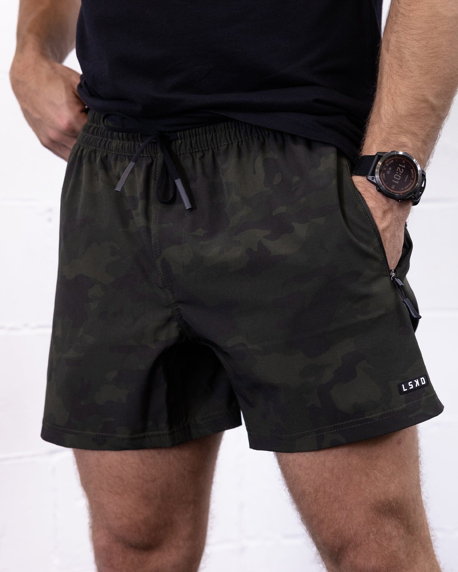 Model wearing Rep 5" Performance Short - Dark Olive Camo