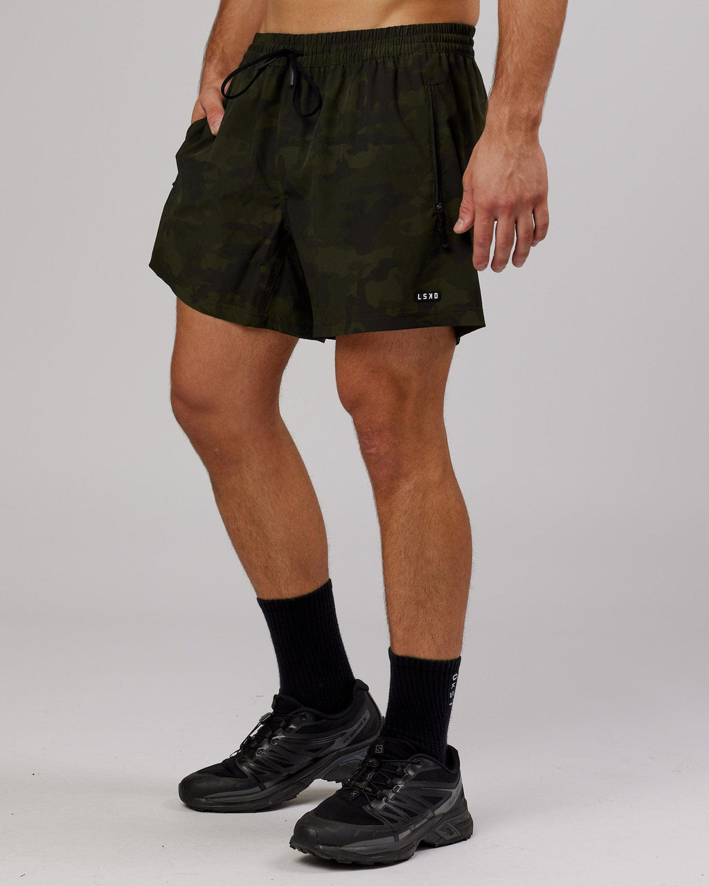 Model wearing Rep 5" Performance Short - Dark Olive Camo