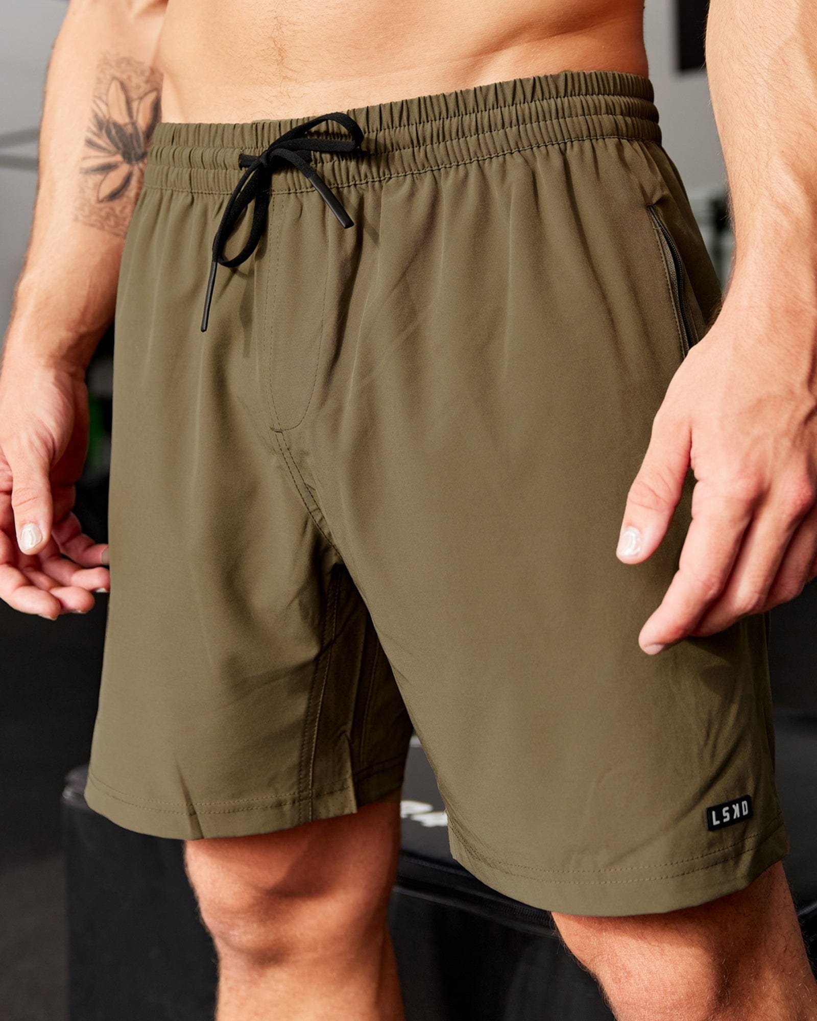 Model wearing Rep 7'' Performance Short - Army Green