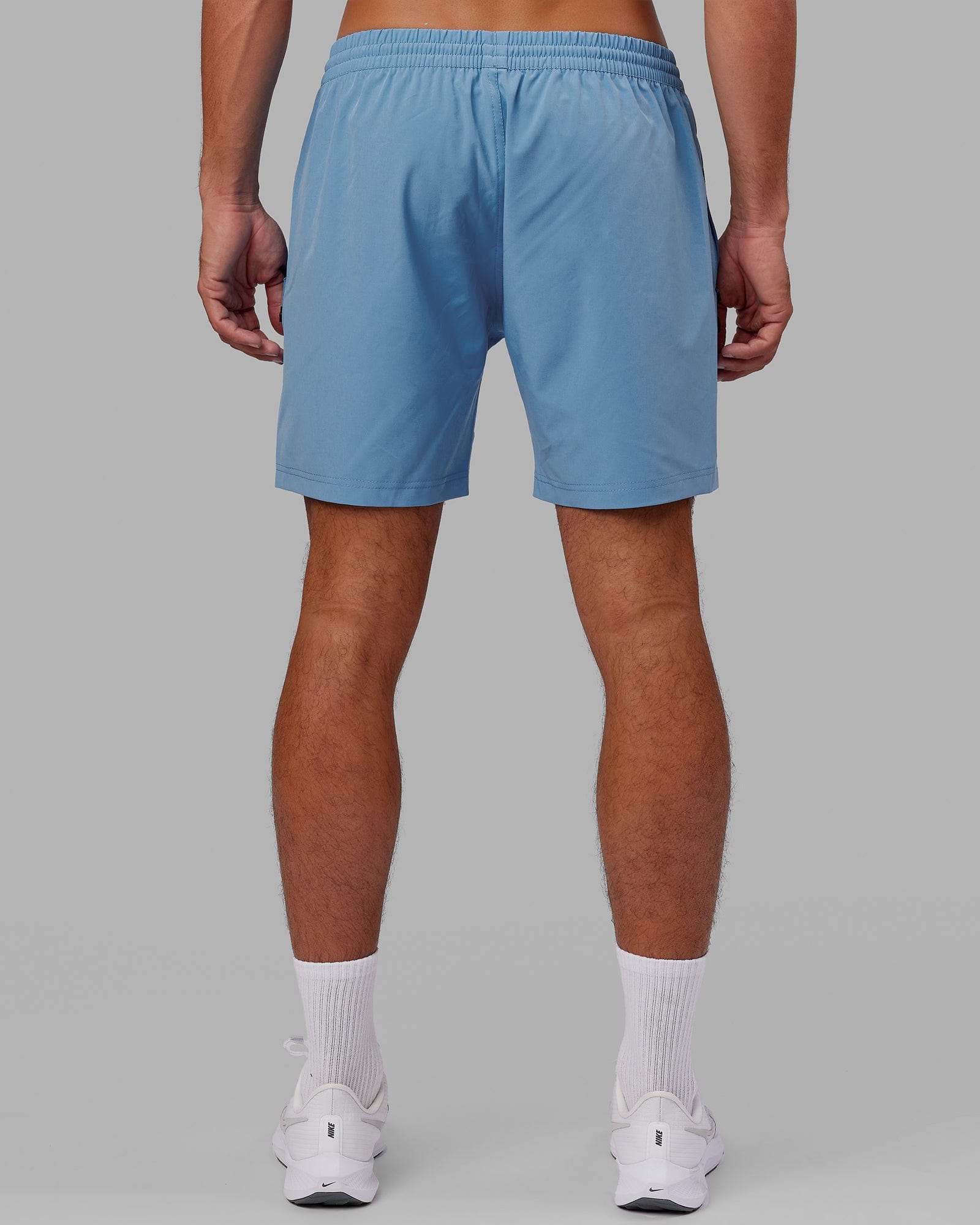 Model wearing Rep 7" Performance Short - Azure Blue