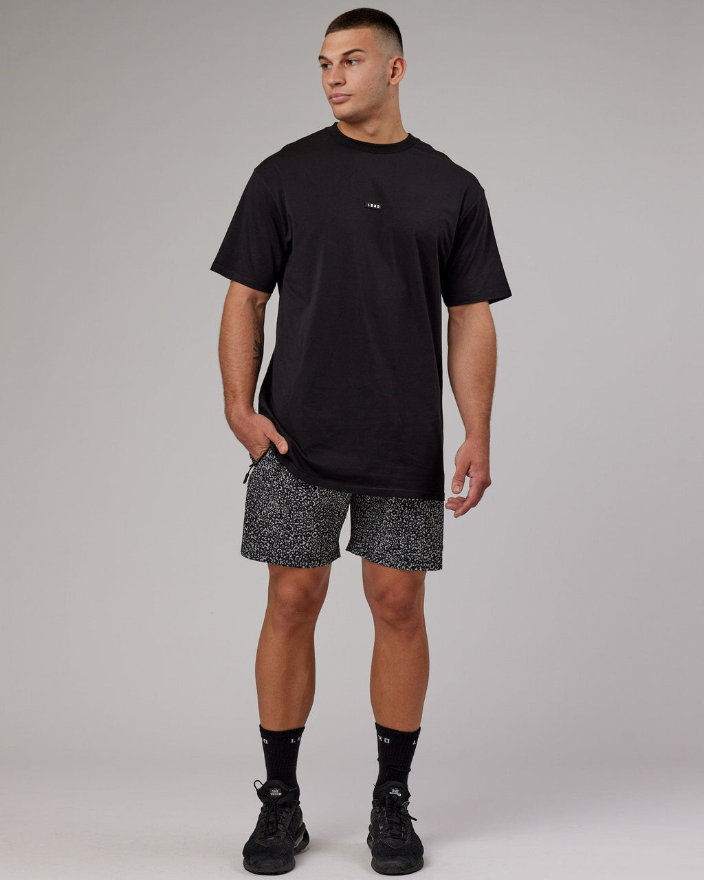 Model wearing Rep 7" Performance Short - Black Spotty
