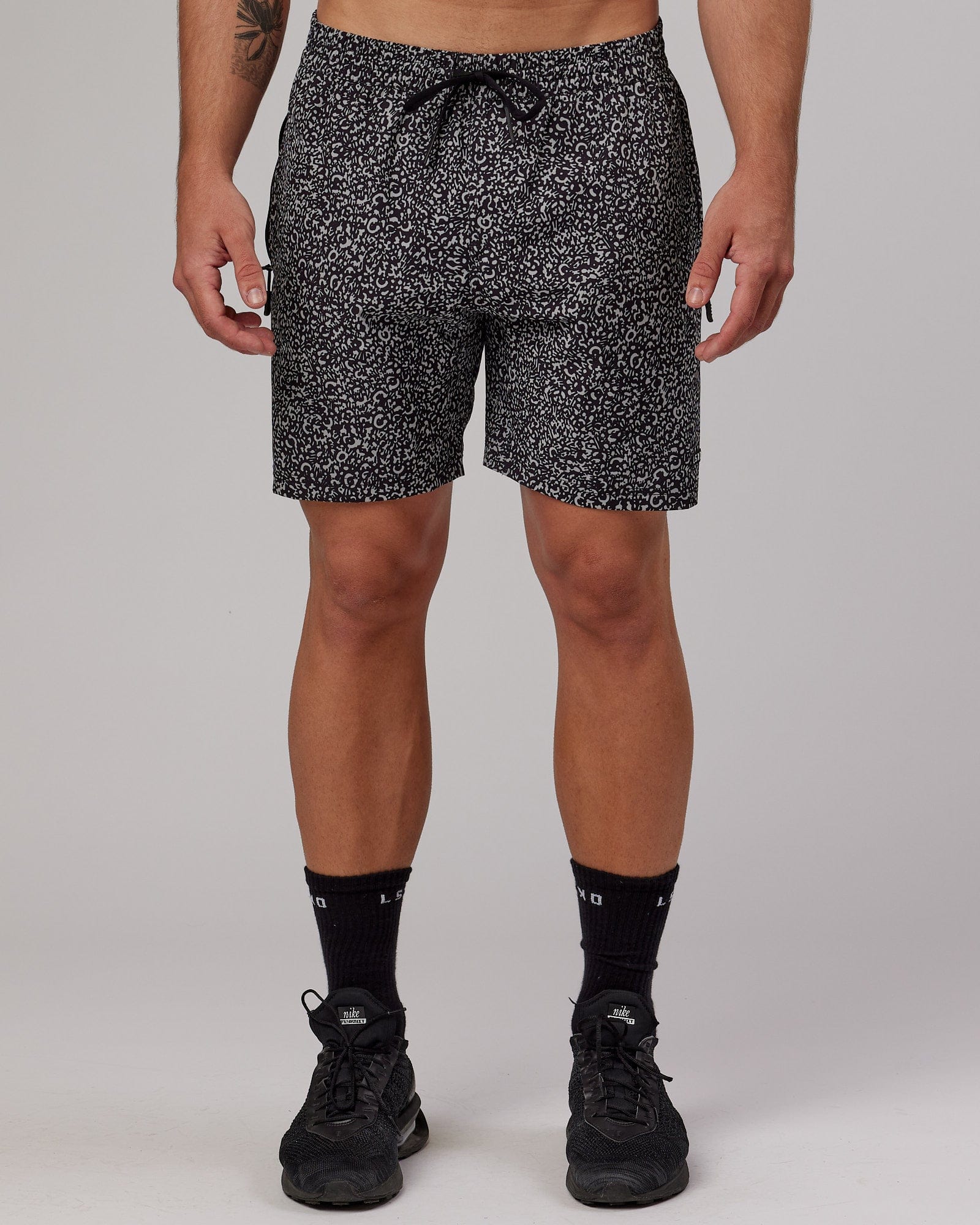 Model wearing Rep 7" Performance Short - Black Spotty