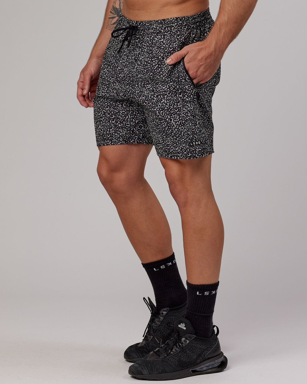 Model wearing Rep 7" Performance Short - Black Spotty