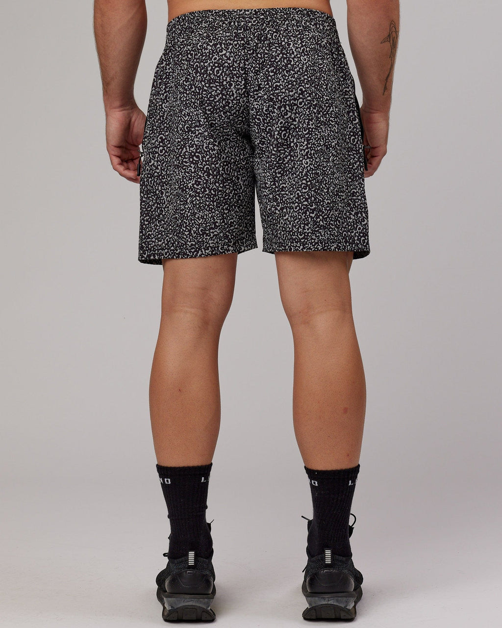 Model wearing Rep 7" Performance Short - Black Spotty