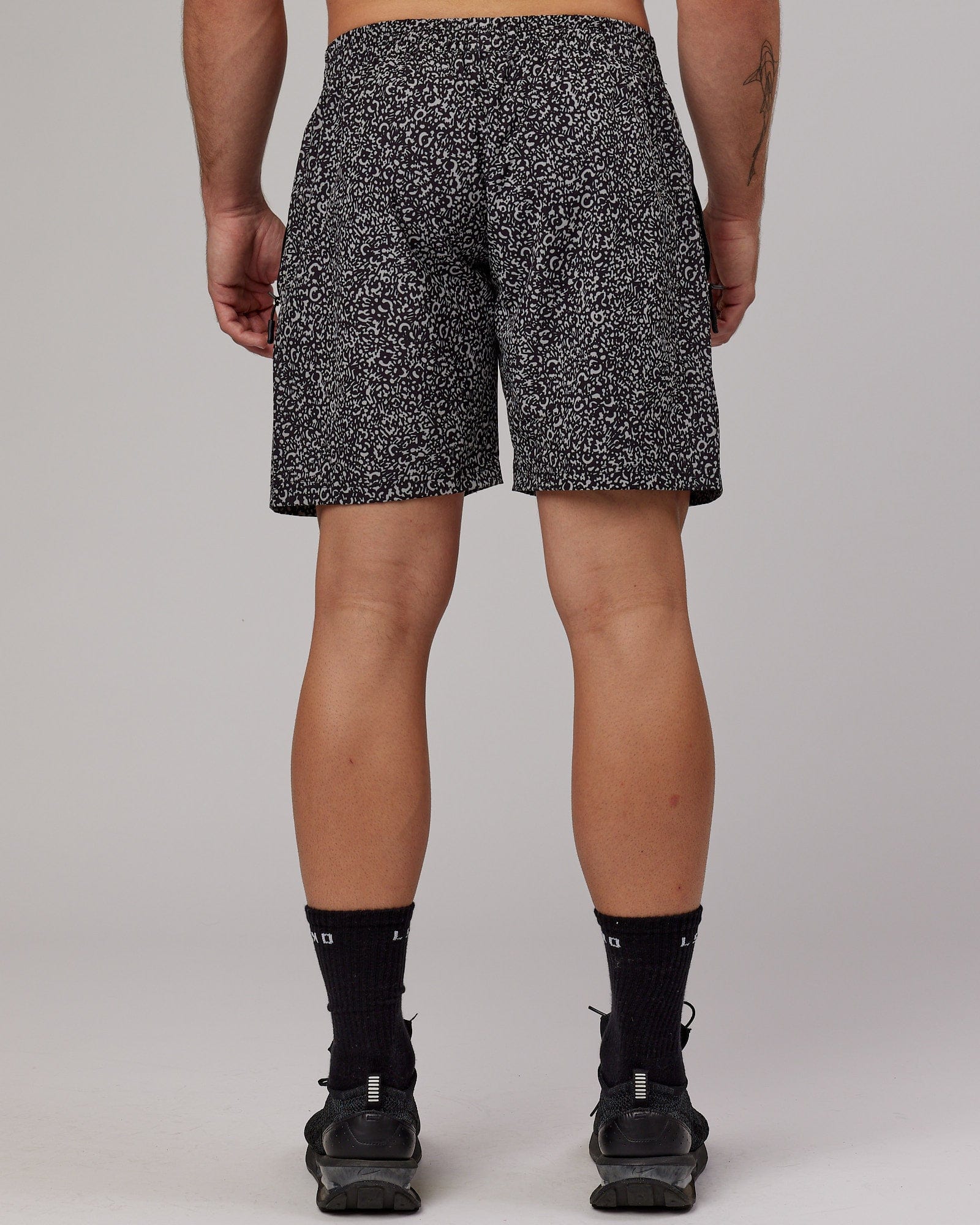 Model wearing Rep 7" Performance Short - Black Spotty