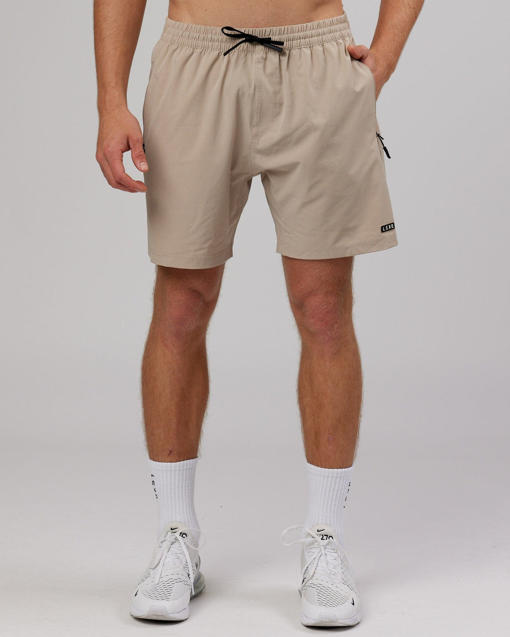 Model wearing Rep 7'' Performance Short - Taupe