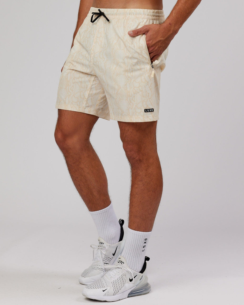 Model wearing Rep 7'' Performance Short - Almond Snakeskin