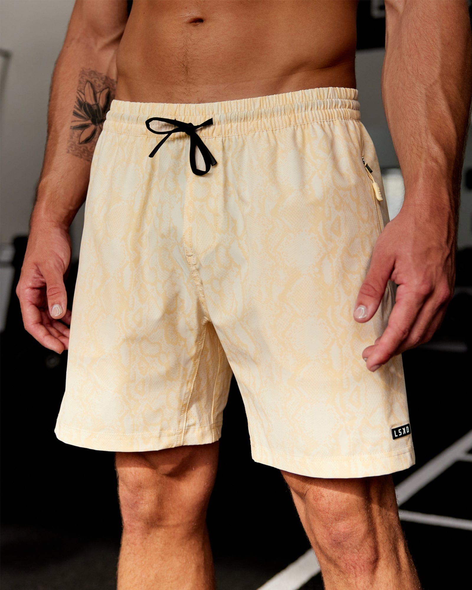 Model wearing Rep 7'' Performance Short - Almond Snakeskin