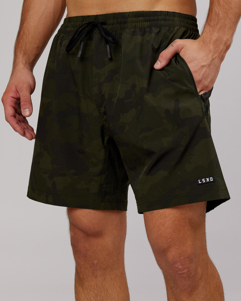 Model wearing Rep 7" Performance Short - Dark Olive Camo
