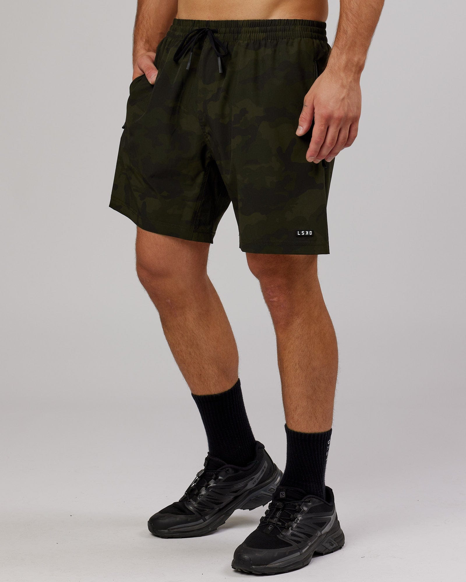 Model wearing Rep 7" Performance Short - Dark Olive Camo