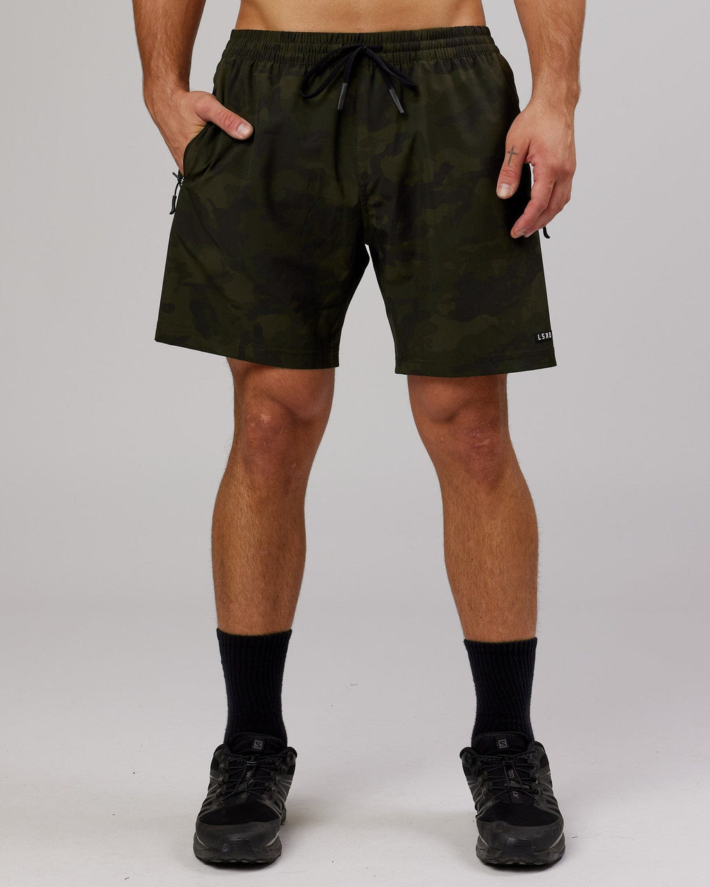 Model wearing Rep 7" Performance Short - Dark Olive Camo