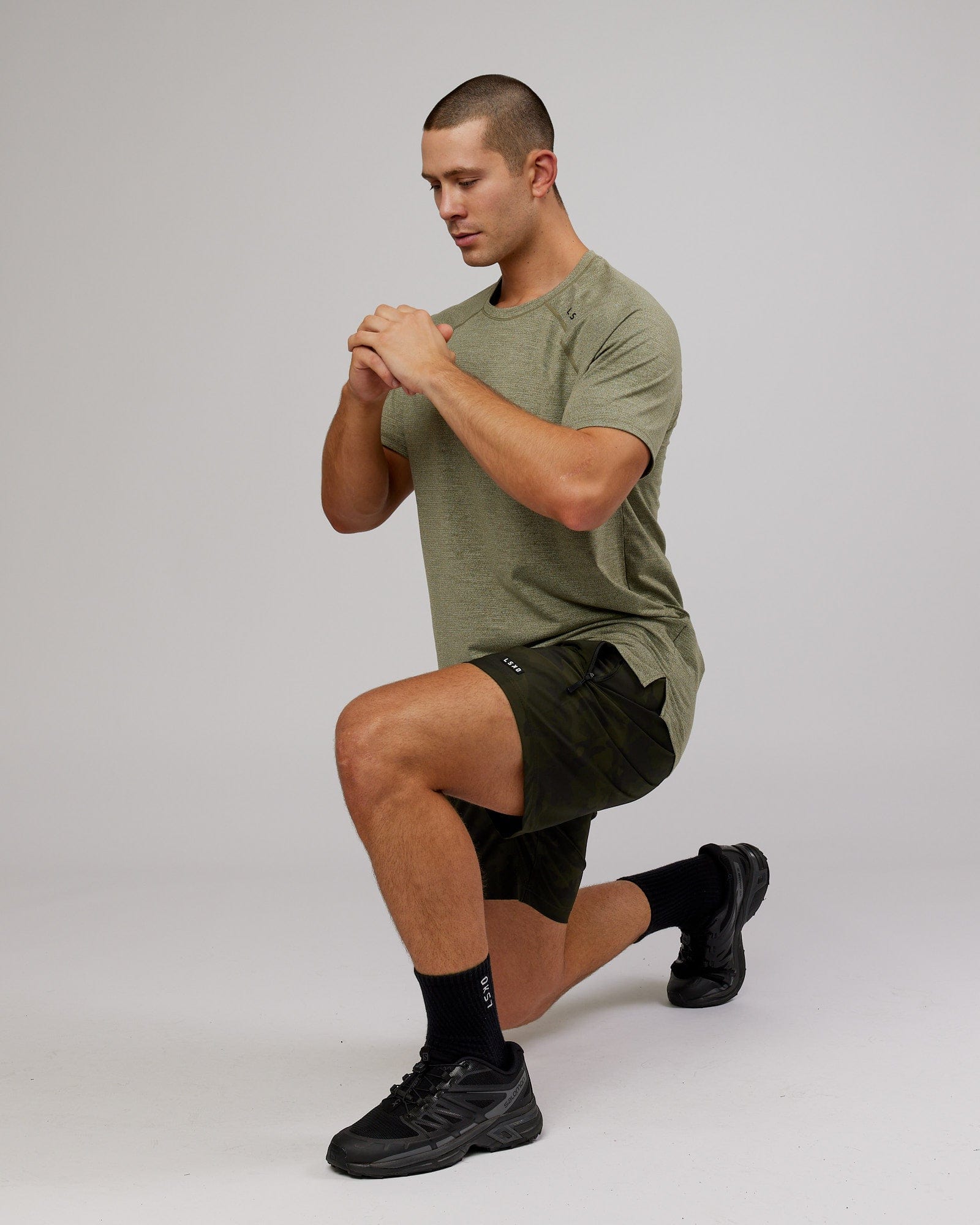 Model wearing Rep 7" Performance Short - Dark Olive Camo