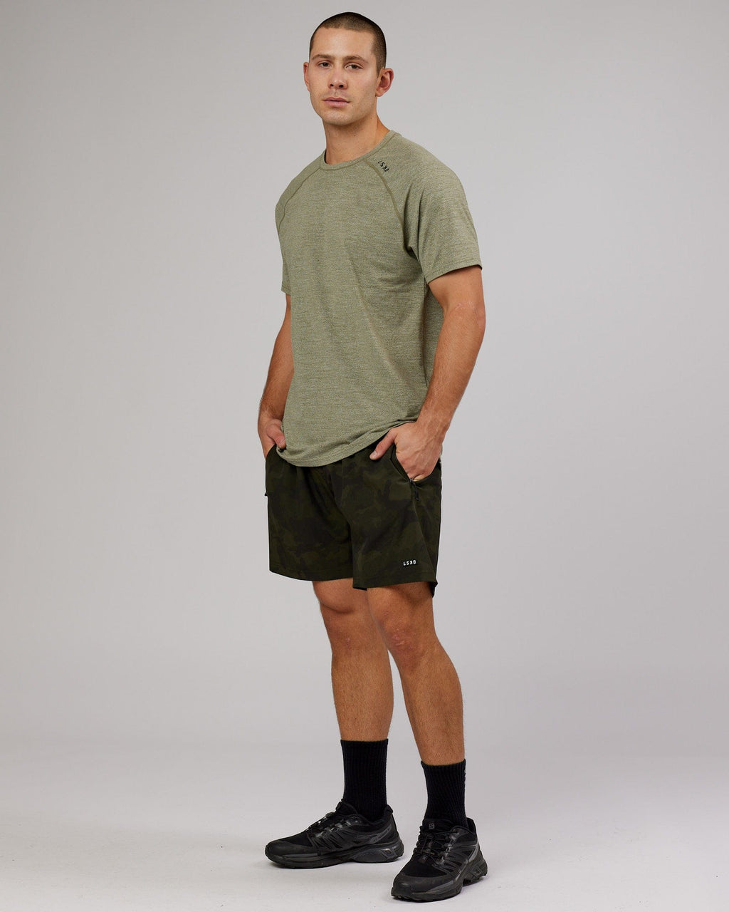 Model wearing Rep 7" Performance Short - Dark Olive Camo