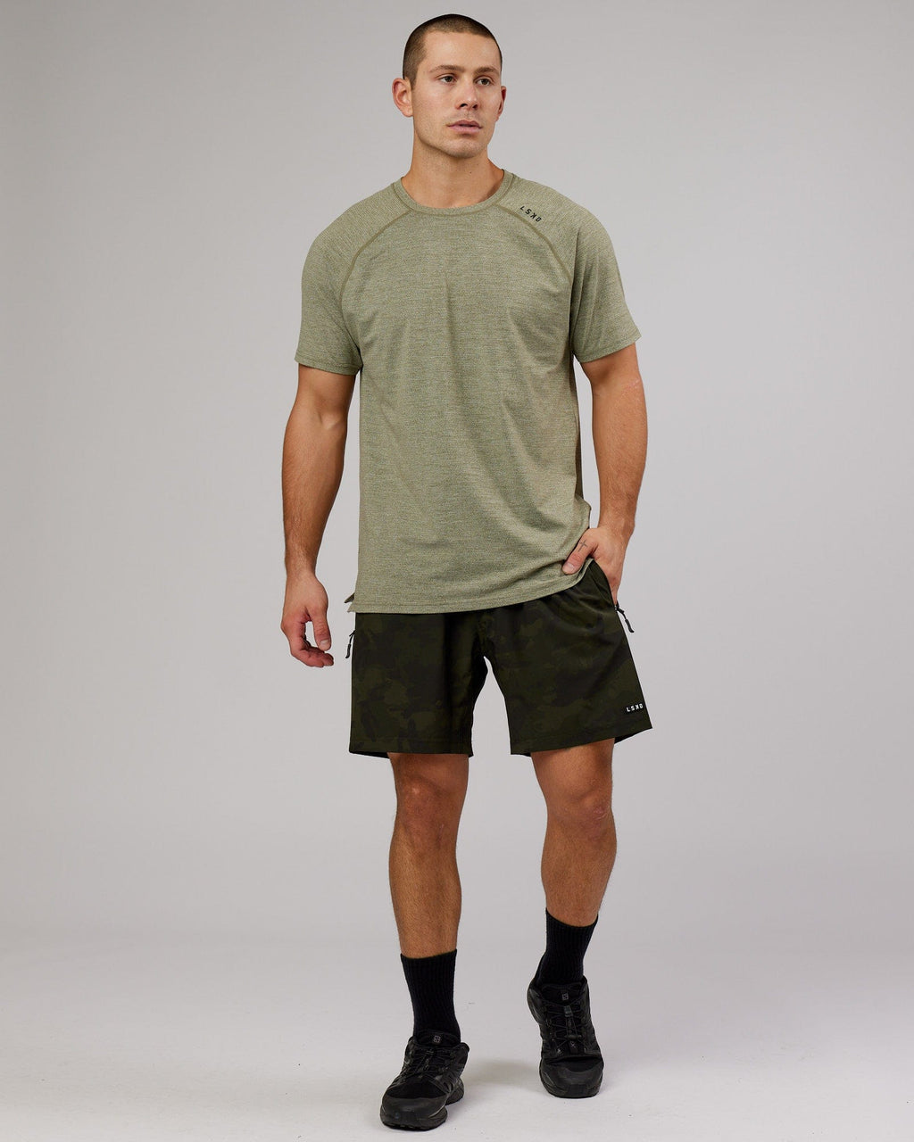 Model wearing Rep 7" Performance Short - Dark Olive Camo