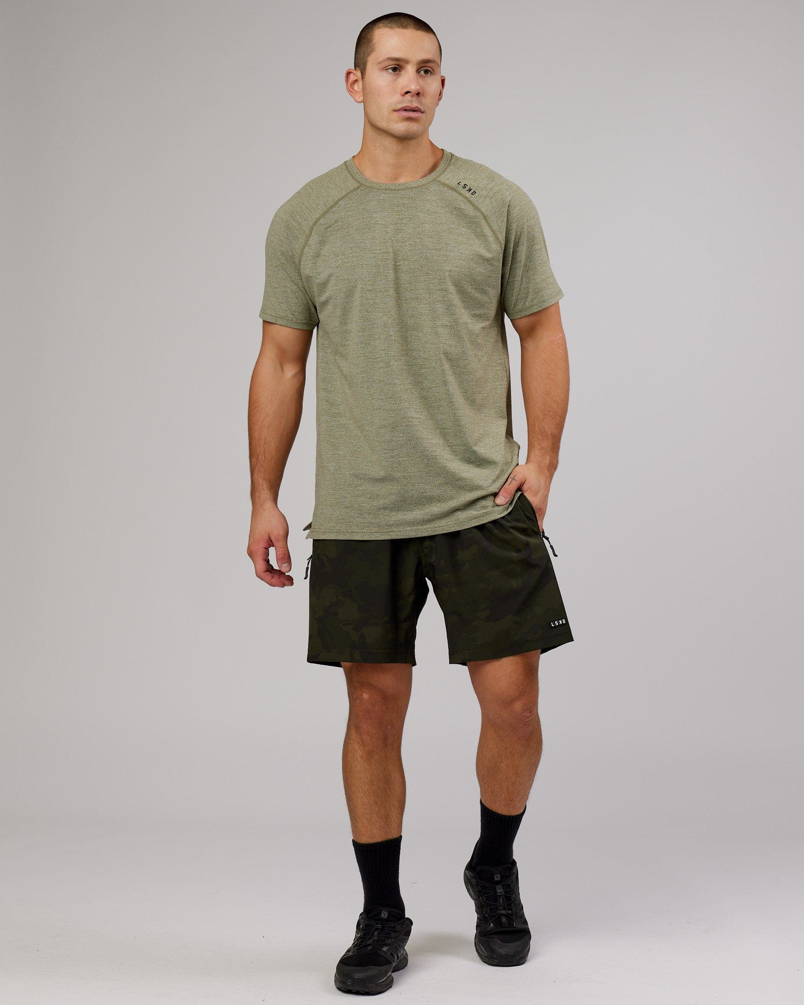 Model wearing Rep 7" Performance Short - Dark Olive Camo
