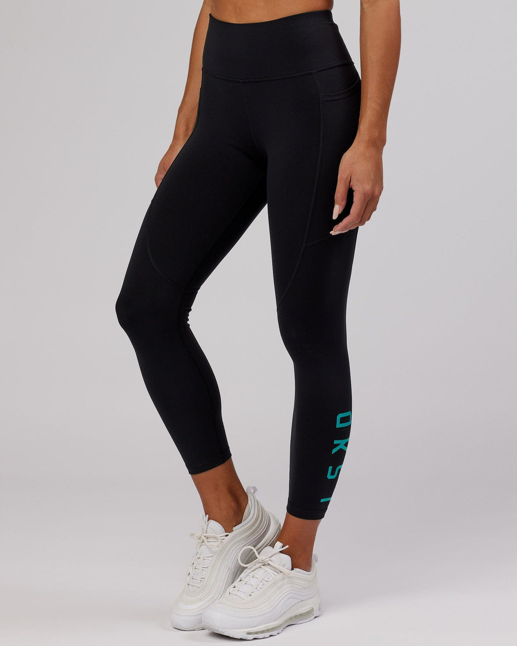 Model wearing Rep 7/8 Length Tight - Black-Hyper Teal