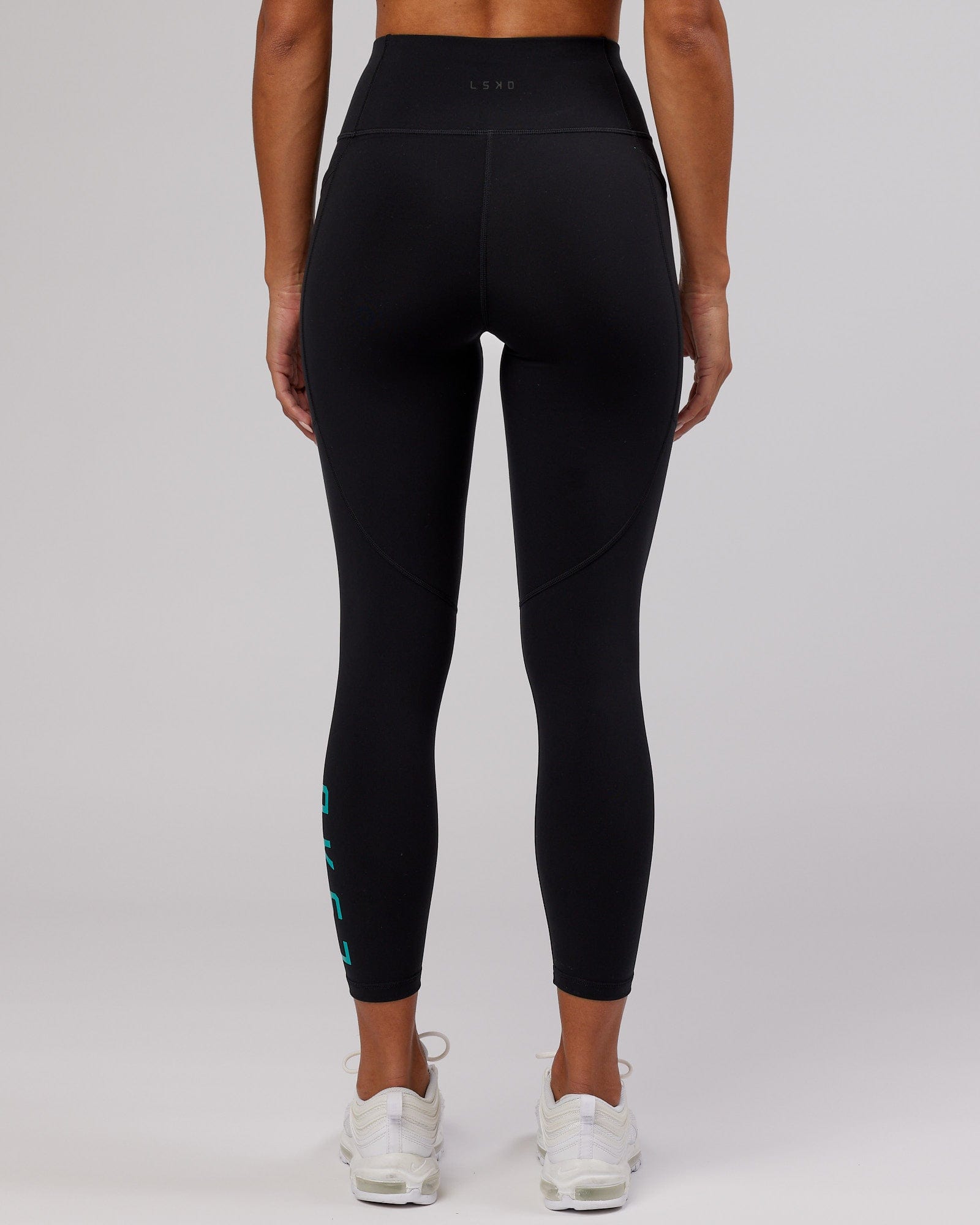 Model wearing Rep 7/8 Length Tight - Black-Hyper Teal
