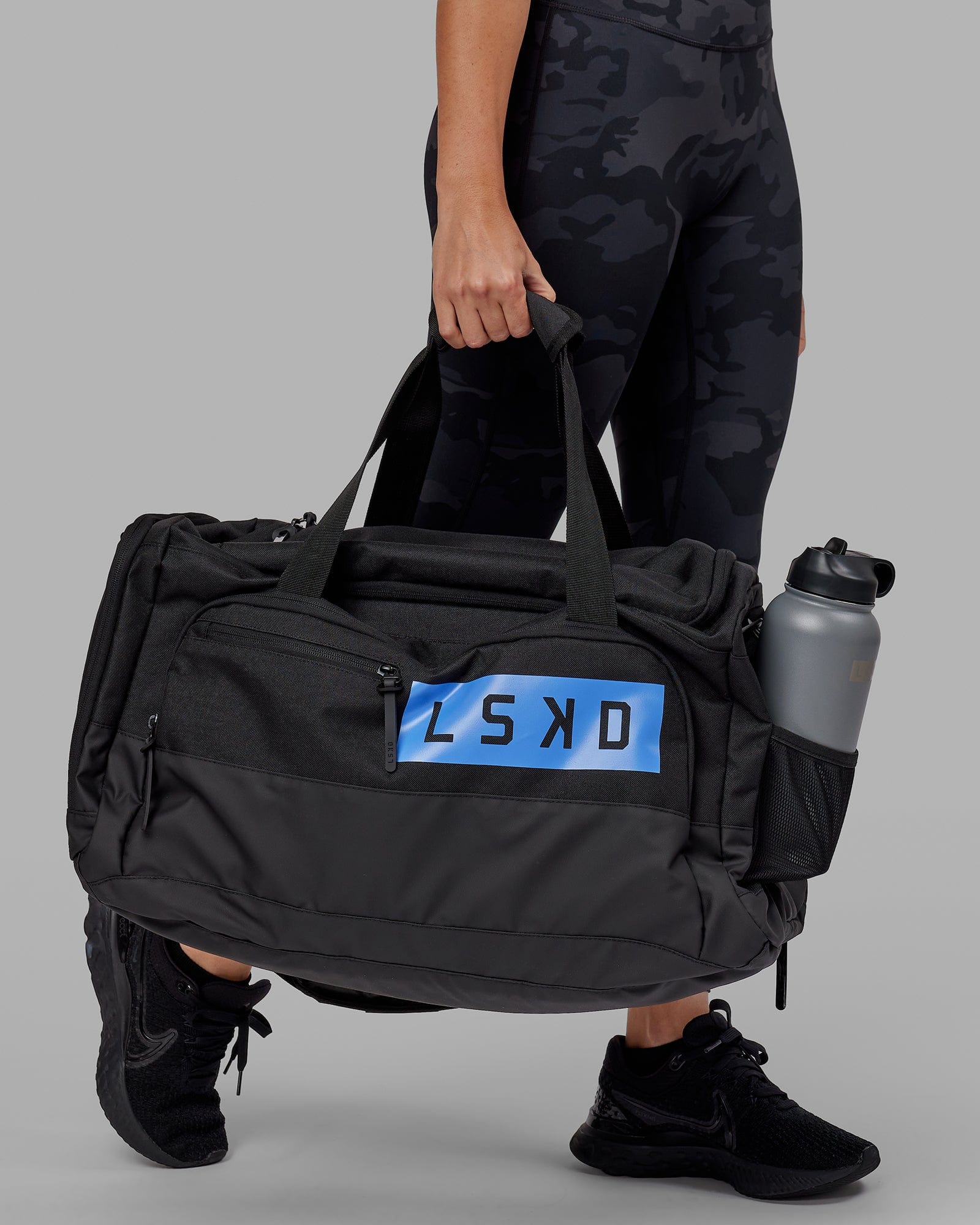 Model wearing Rep Duffle Bag 50L - Black-Cornflower Blue